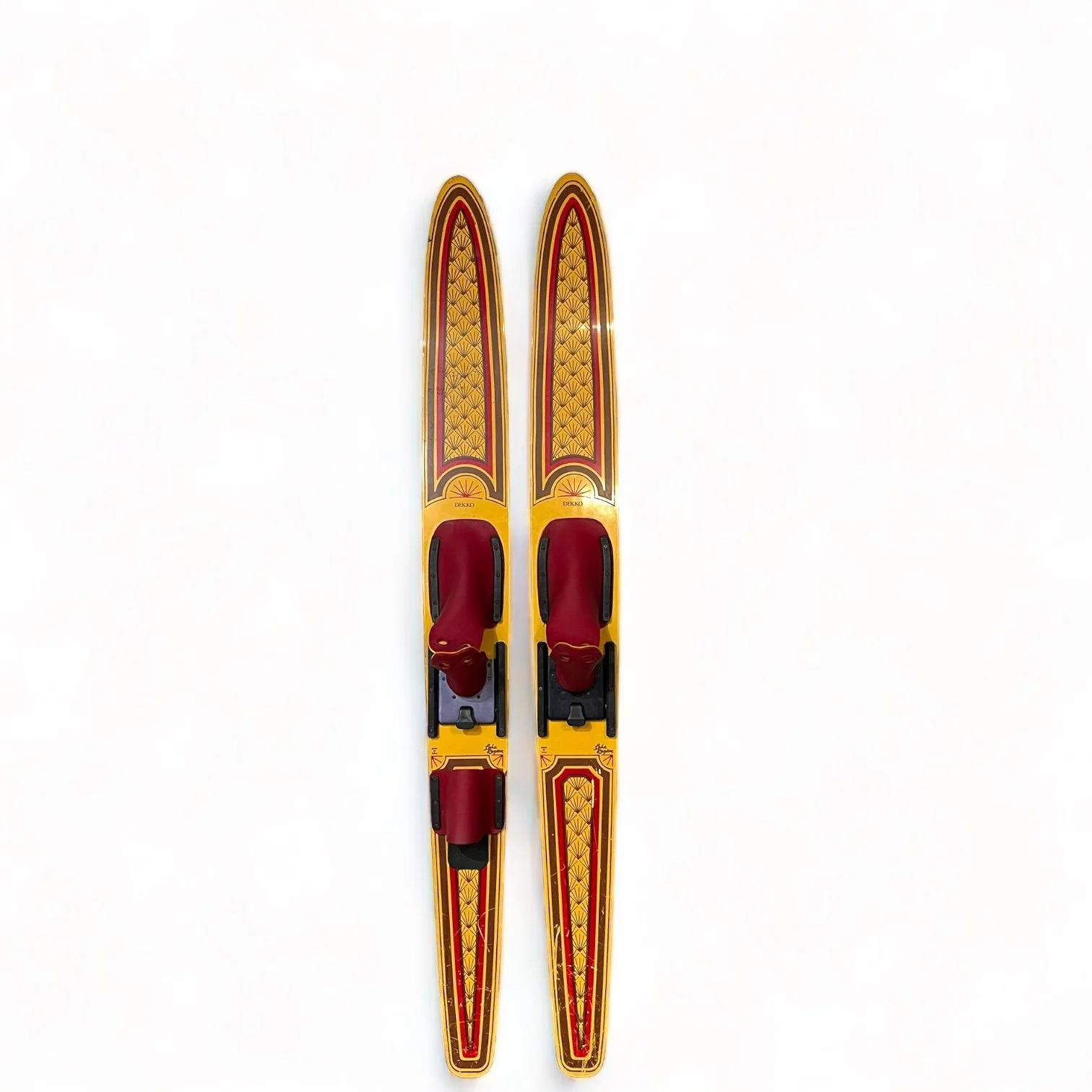 vintage pair of Dekko wooden water skis by Lake Region with an Art Deco pattern in yellow and red.