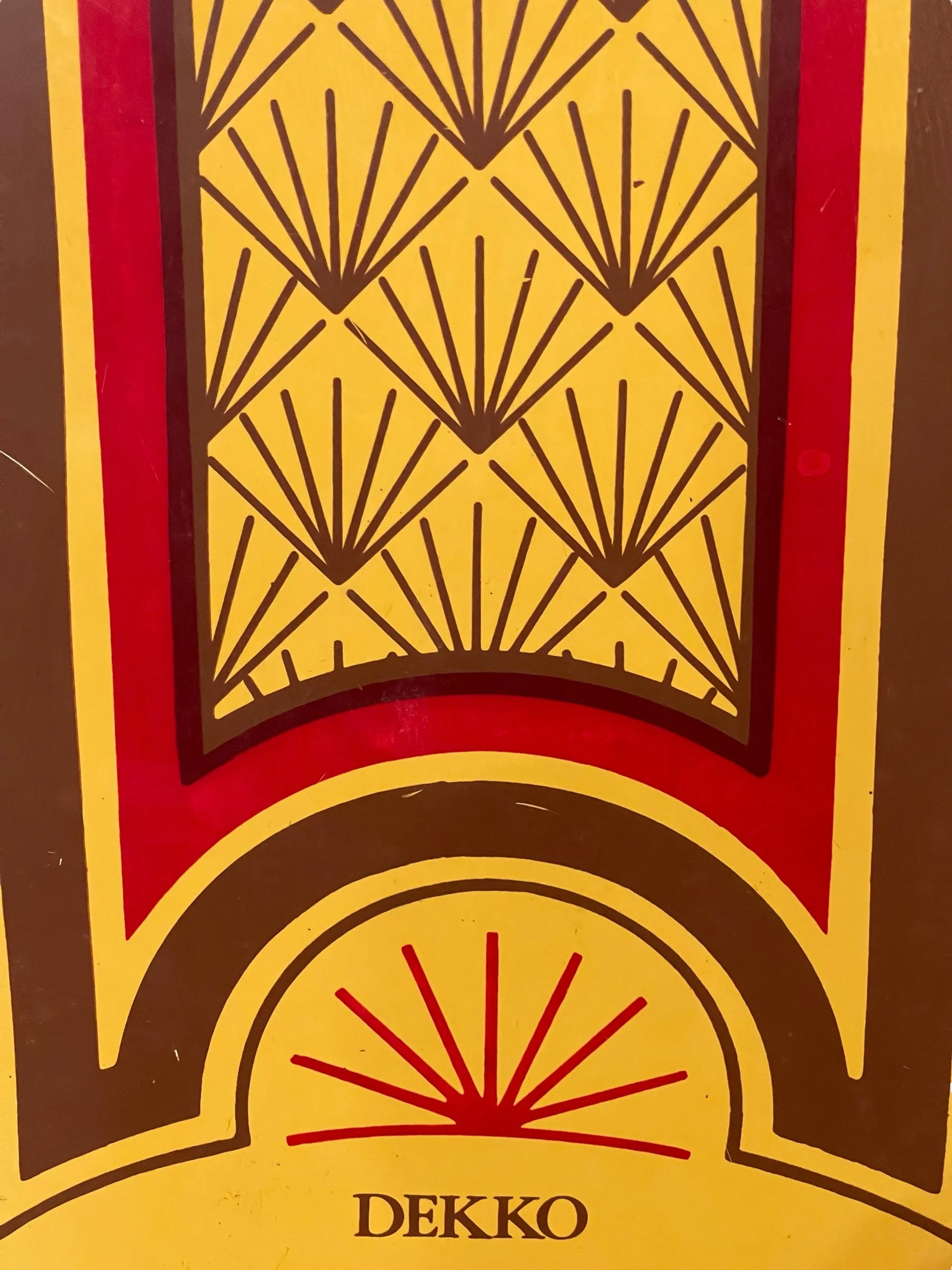 vintage pair of Dekko wooden water skis by Lake Region with an Art Deco pattern in yellow and red.