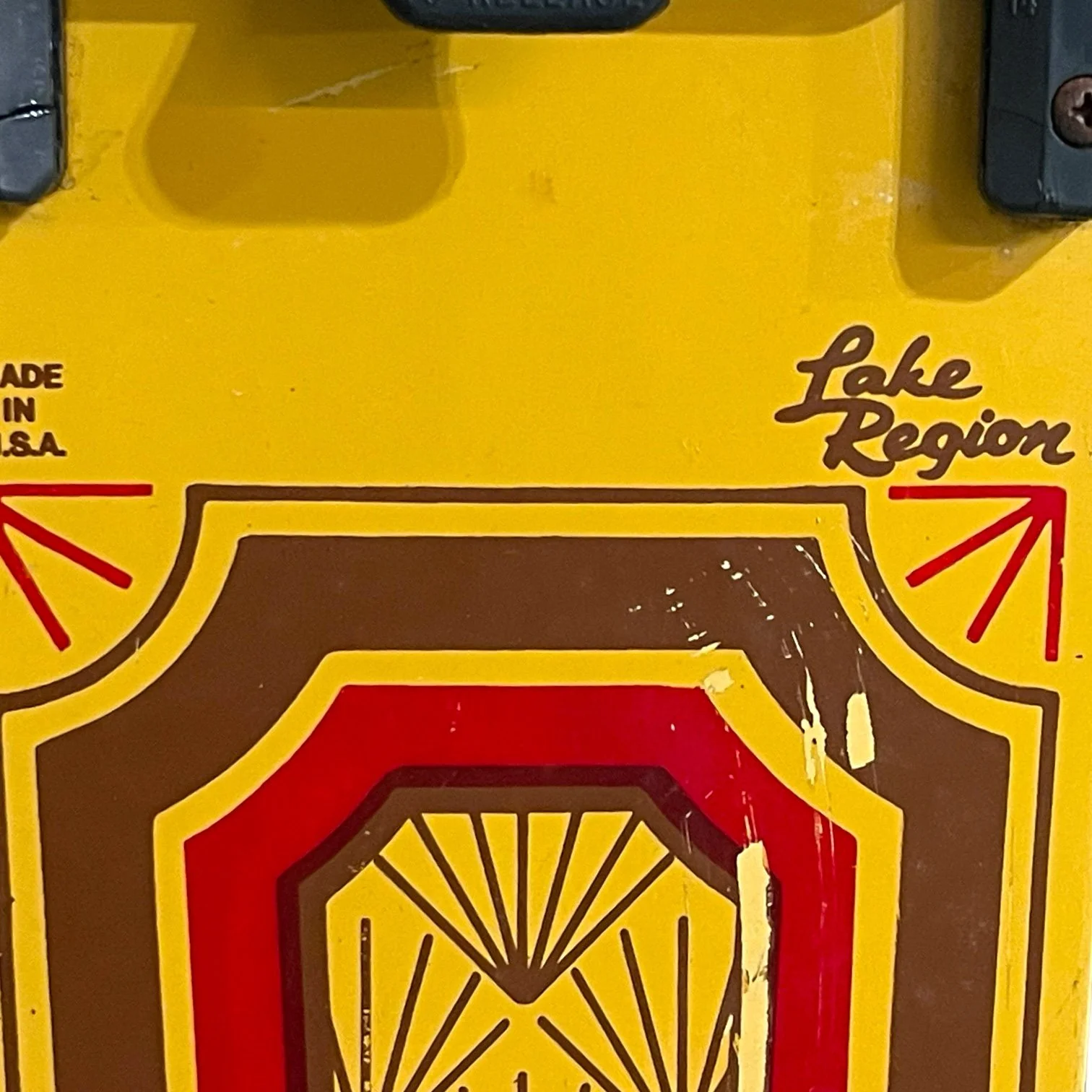 vintage pair of Dekko wooden water skis by Lake Region with an Art Deco pattern in yellow and red.