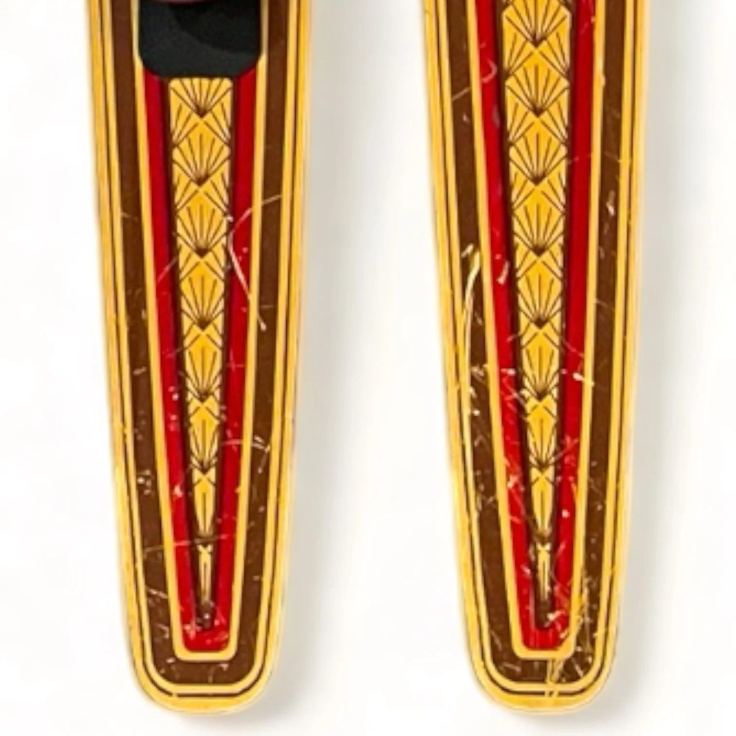 vintage pair of Dekko wooden water skis by Lake Region with an Art Deco pattern in yellow and red.