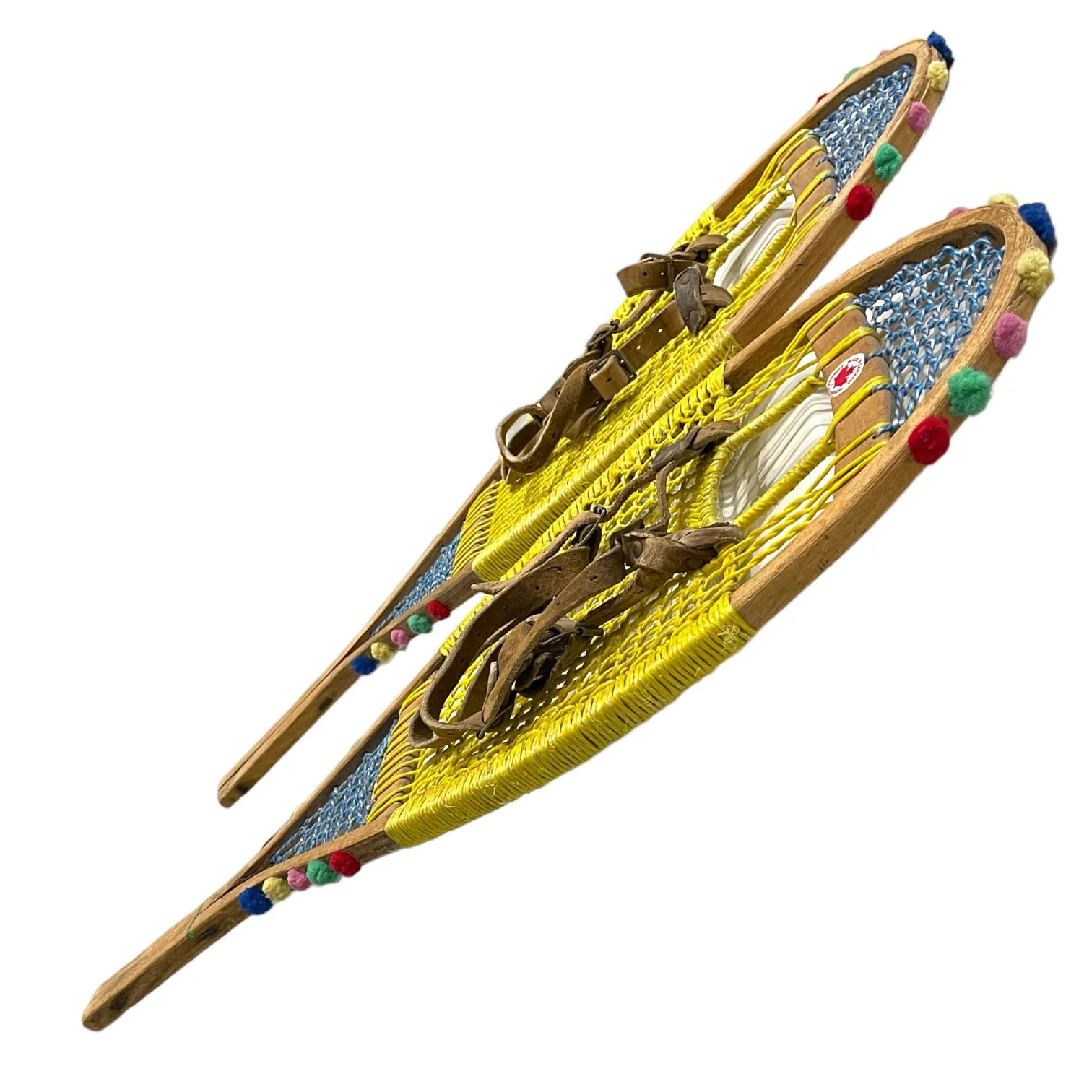 Yellow and blue wooden vintage snowshoes with leather straps.
