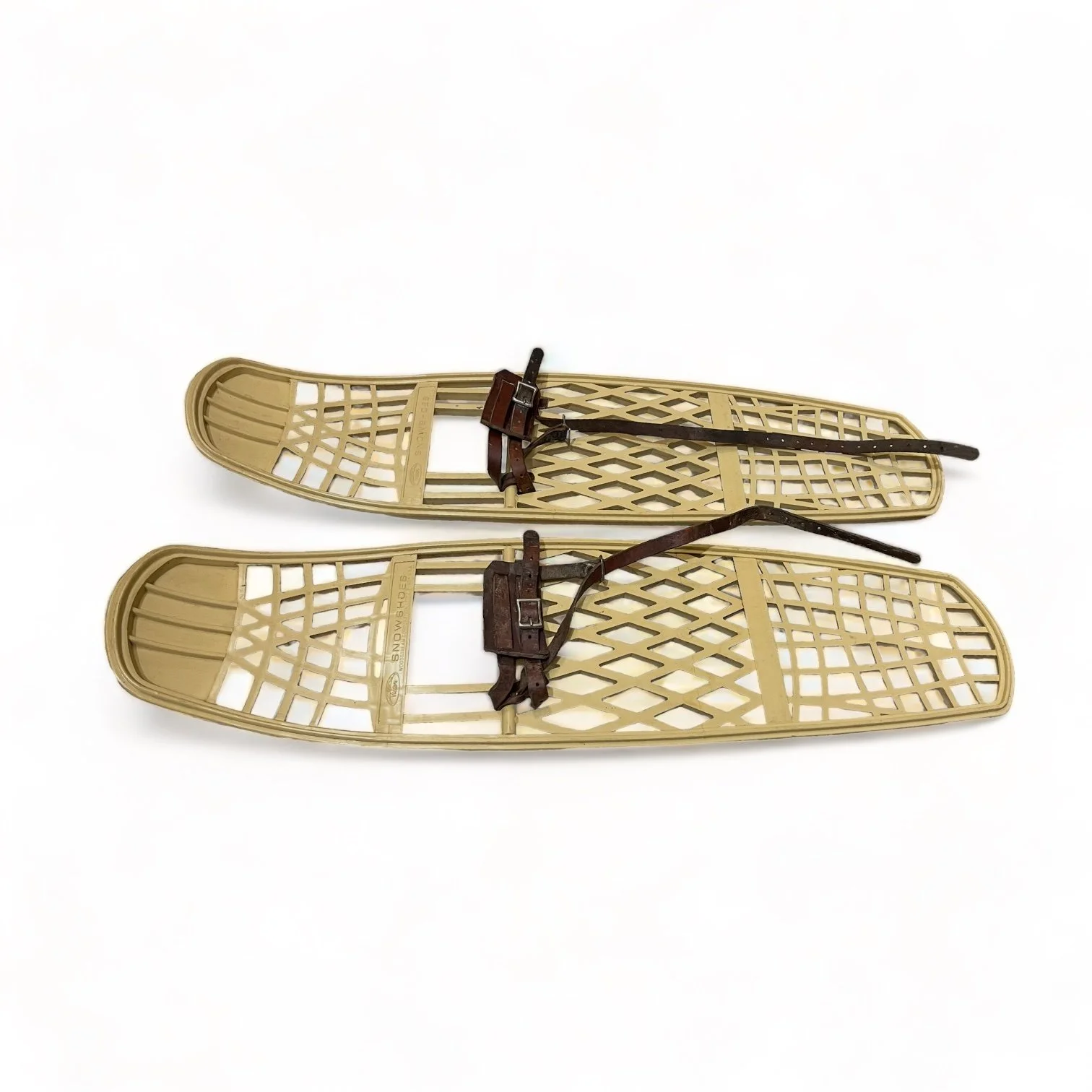 Pair of beige plastic Victor snowshoes with leather bindings.