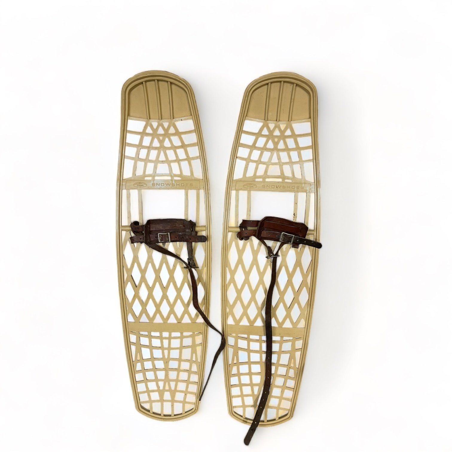 Pair of beige plastic Victor snowshoes with leather bindings.