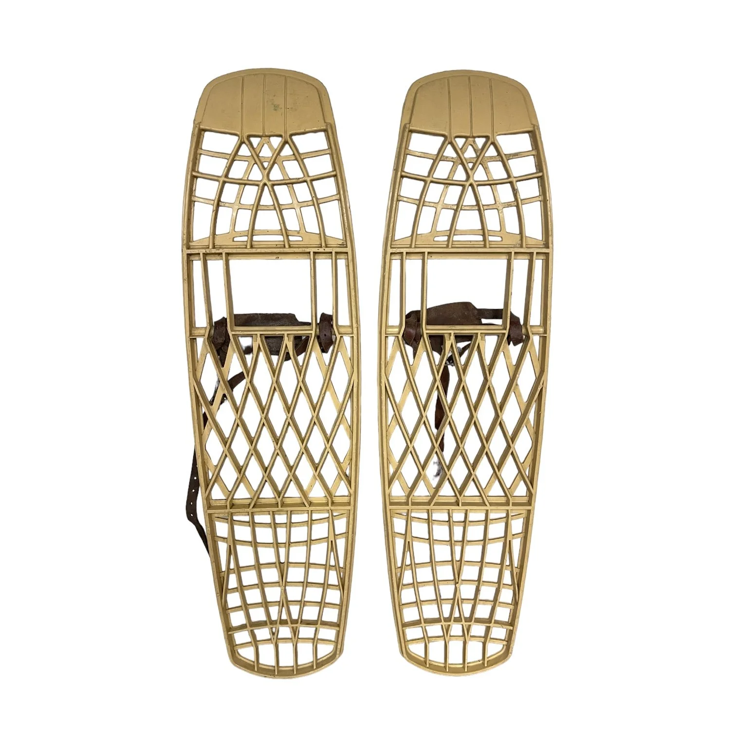 Pair of beige plastic Victor snowshoes with leather bindings.