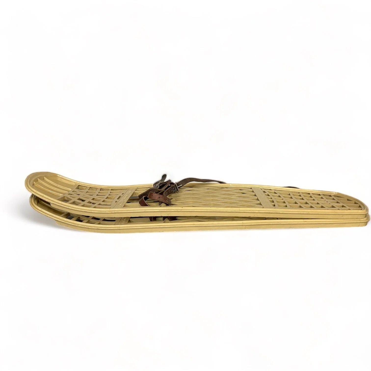 Pair of beige plastic Victor snowshoes with leather bindings.