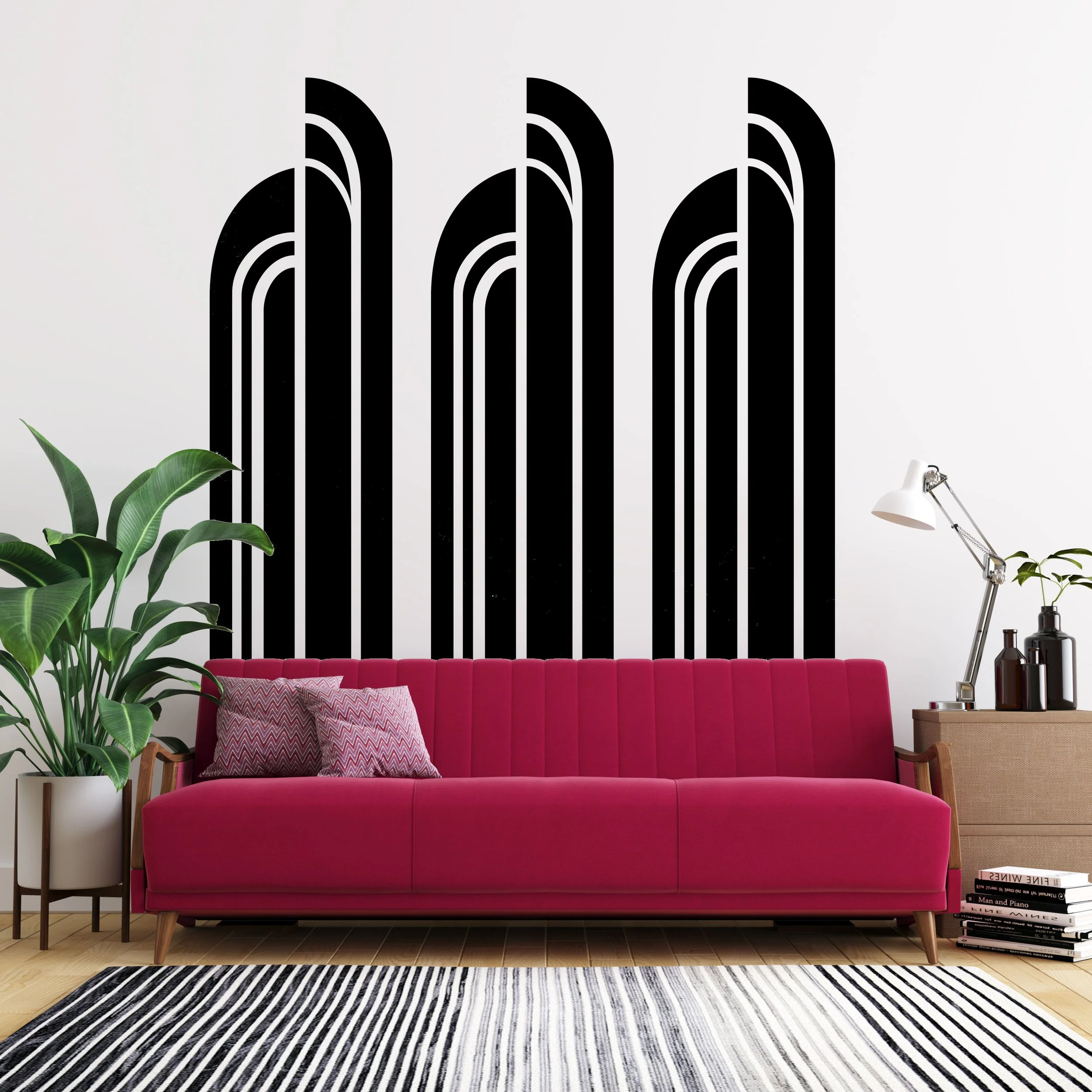 Art Deco style arches vinyl wall decal by Wall Star Graphics shown in black on a white wall above a bright pink couch.