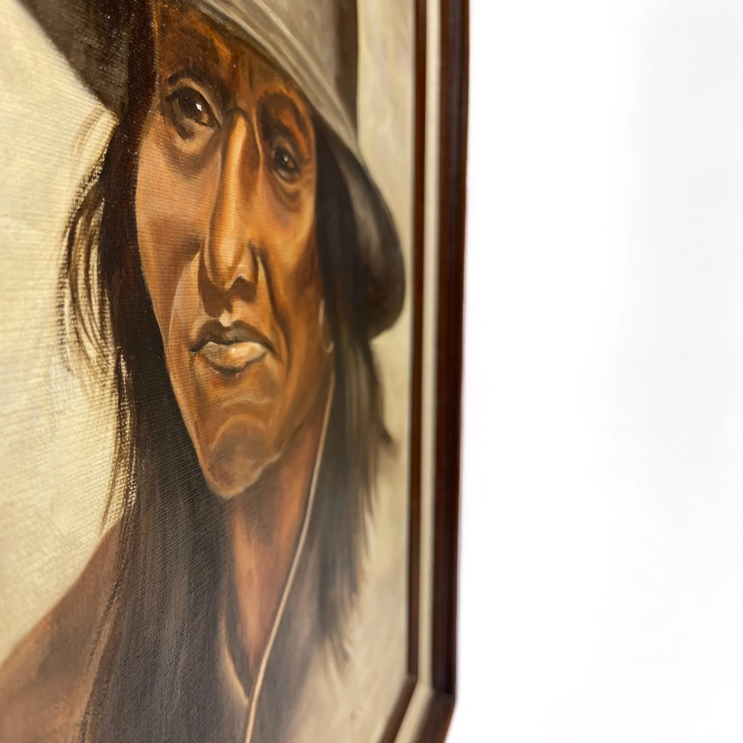 Vintage framed Painting of Native Man in Western Hat signed by artist. Painting is done in a combination of earth tone colors.