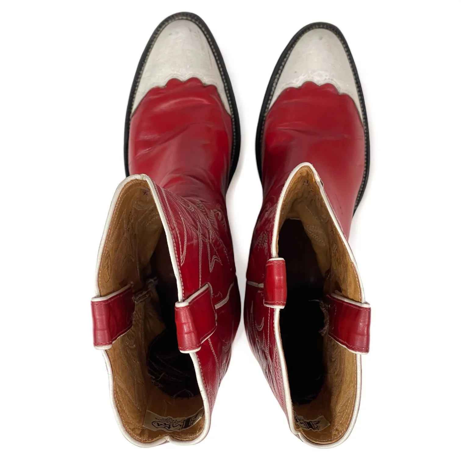 Top view of a vintage pair women's 1970s Justin two toned red and white leather cowboy boots, style L4069, size 8 1/2 B