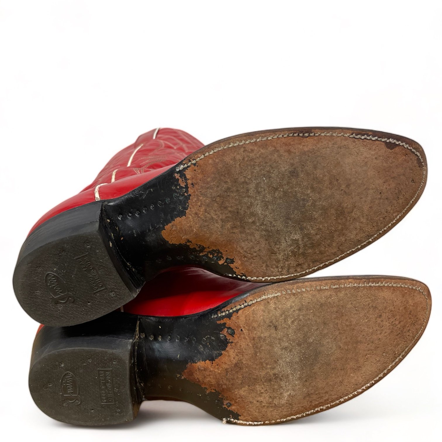 Bottom view of a vintage pair women's 1970s Justin two toned red and white leather cowboy boots, style L4069, size 8 1/2 B