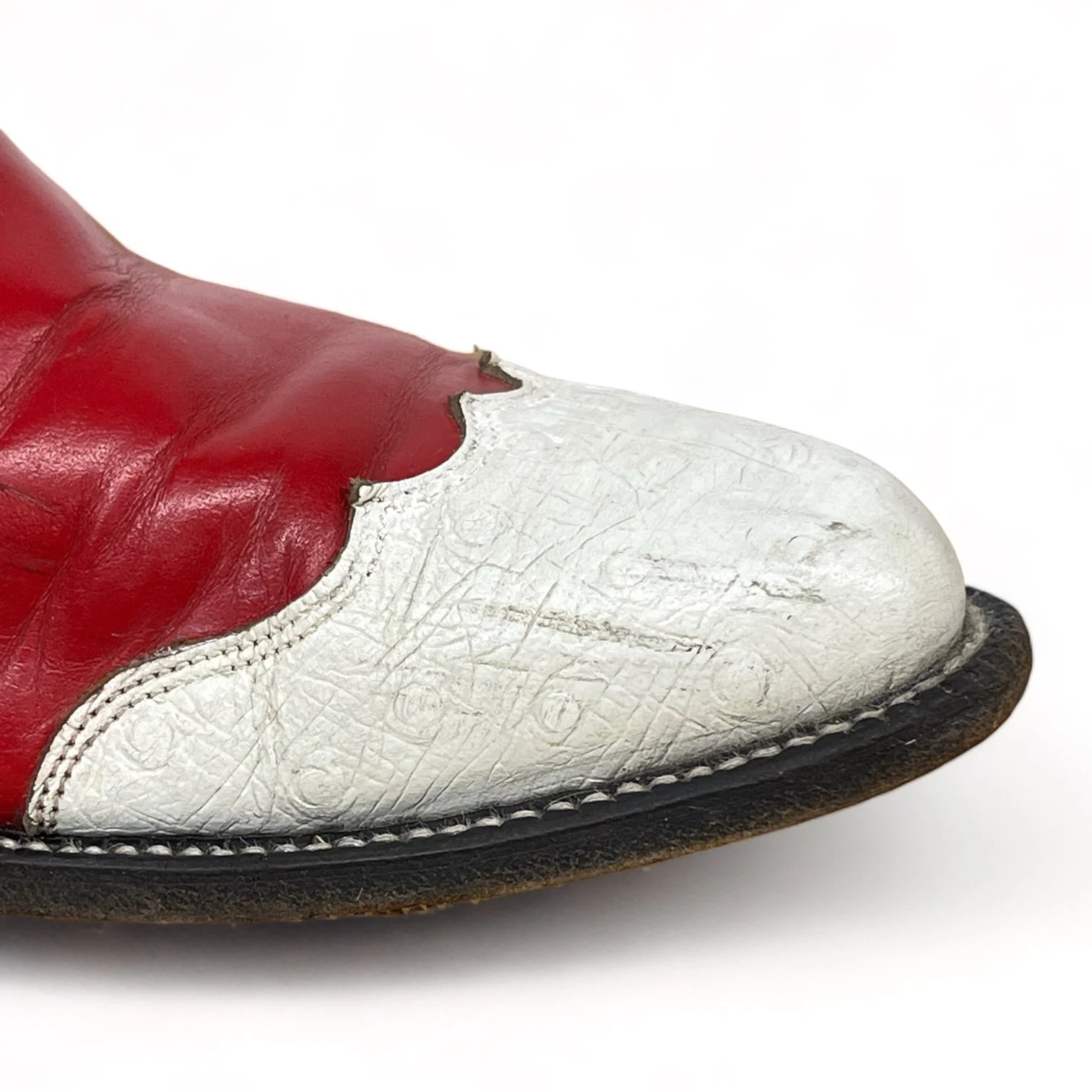 Close up view of a vintage pair women's 1970s Justin two toned red and white leather cowboy boots, style L4069, size 8 1/2 B