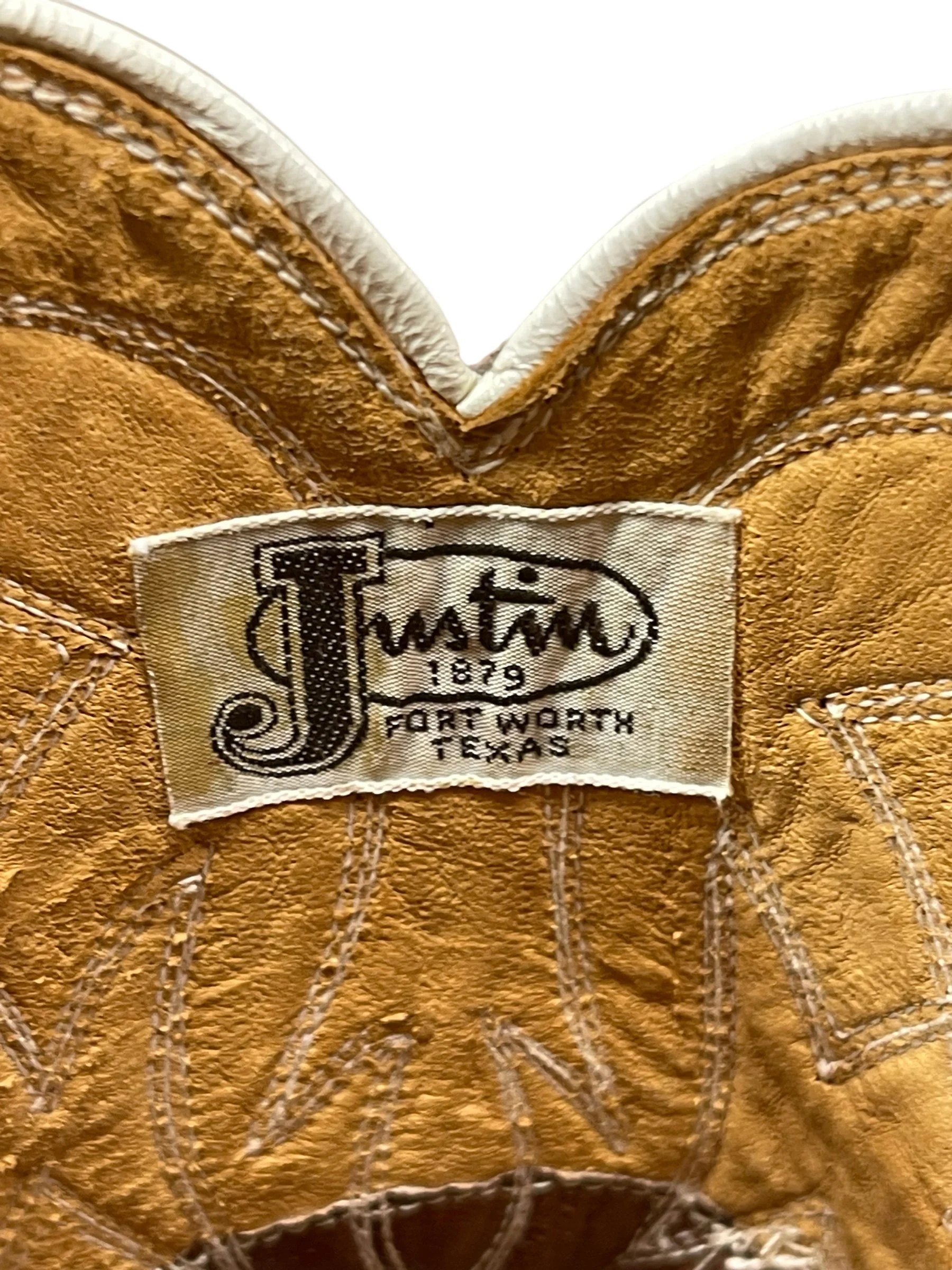 A brand label in a vintage pair women's 1970s Justin two toned red and white leather cowboy boots, style L4069, size 8 1/2 B