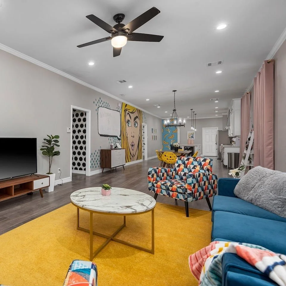 Black polka dot wall decals shown on a white wall of a retro living room.