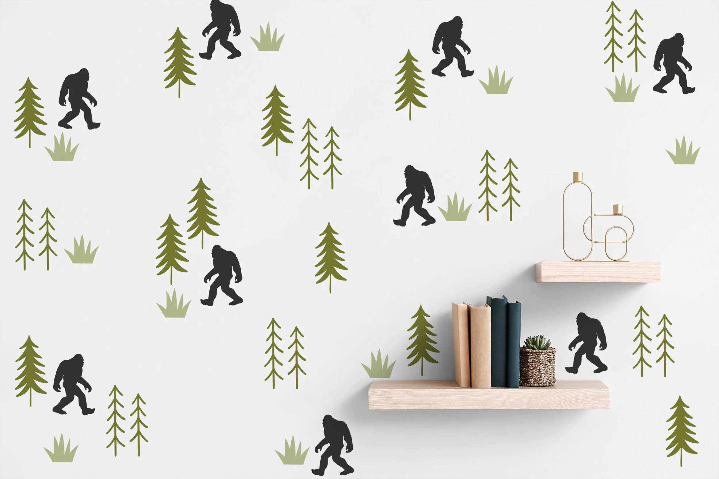 Bigfoot and pine tree wall decals on a white wall with a bookshelf.