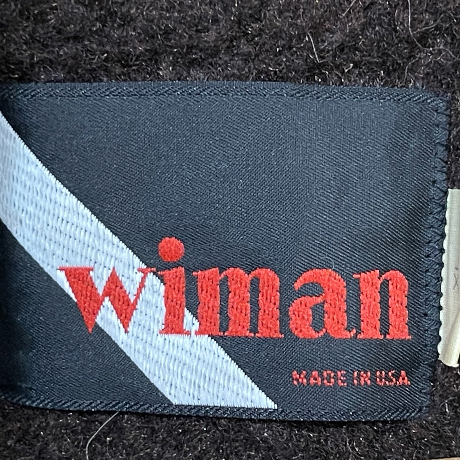 A label from a vintage men's Wiman sherpa lined jacket. Made in USA. Size XL.