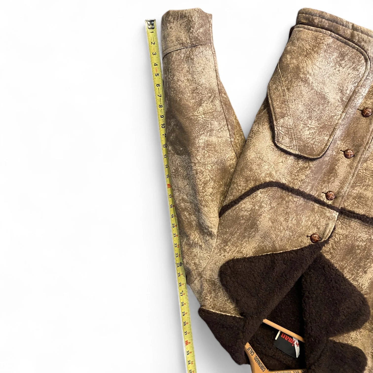 A vintage men's Sherpa Lined Rancher Jacket hanging on a vintage wooden hanger. Size XL Made in USA, Classic Ranch Style Western Wear, by Wiman.