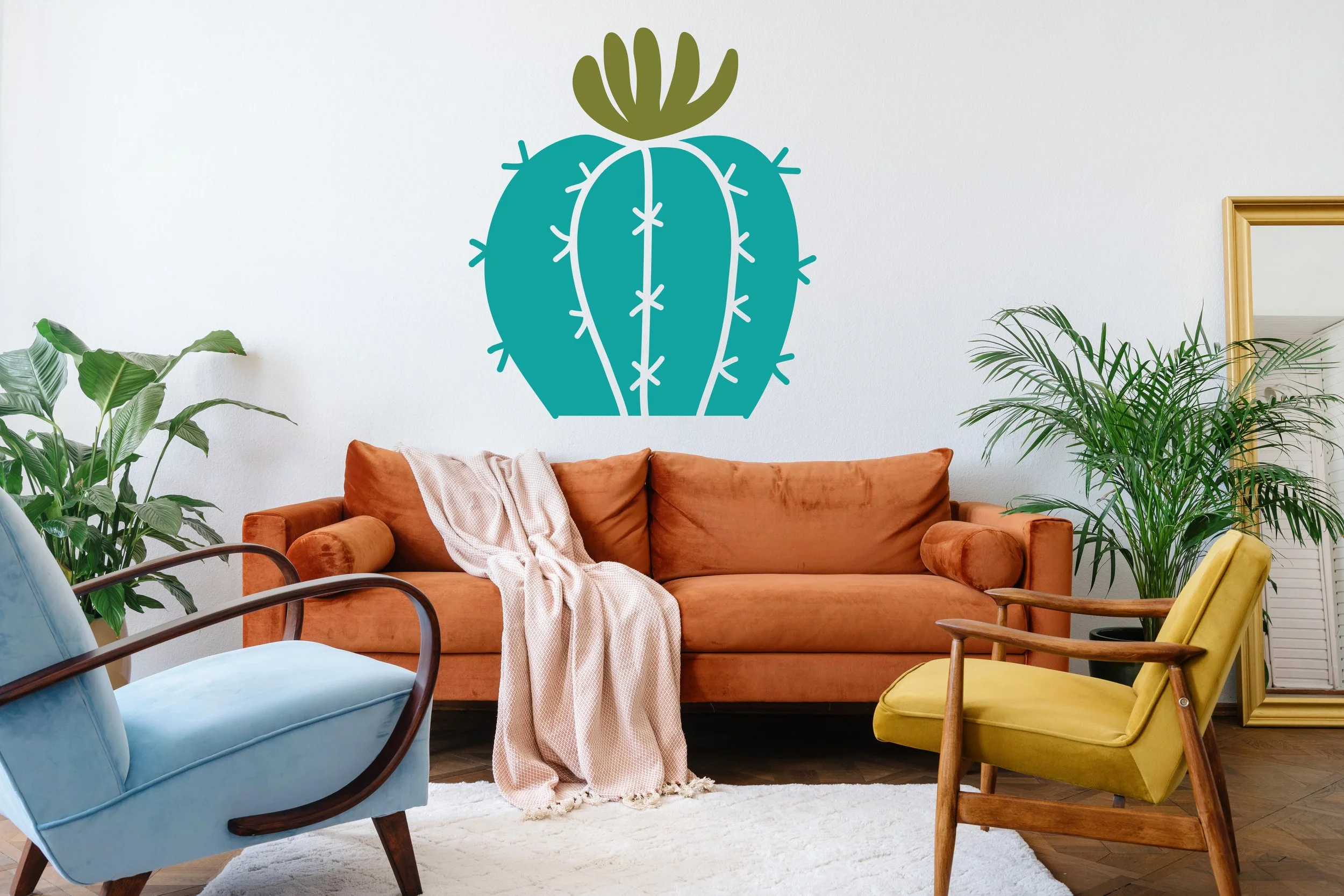 Blooming barrel cactus two color wall decal shown in turquoise and olive on a white wall of a modern living room.