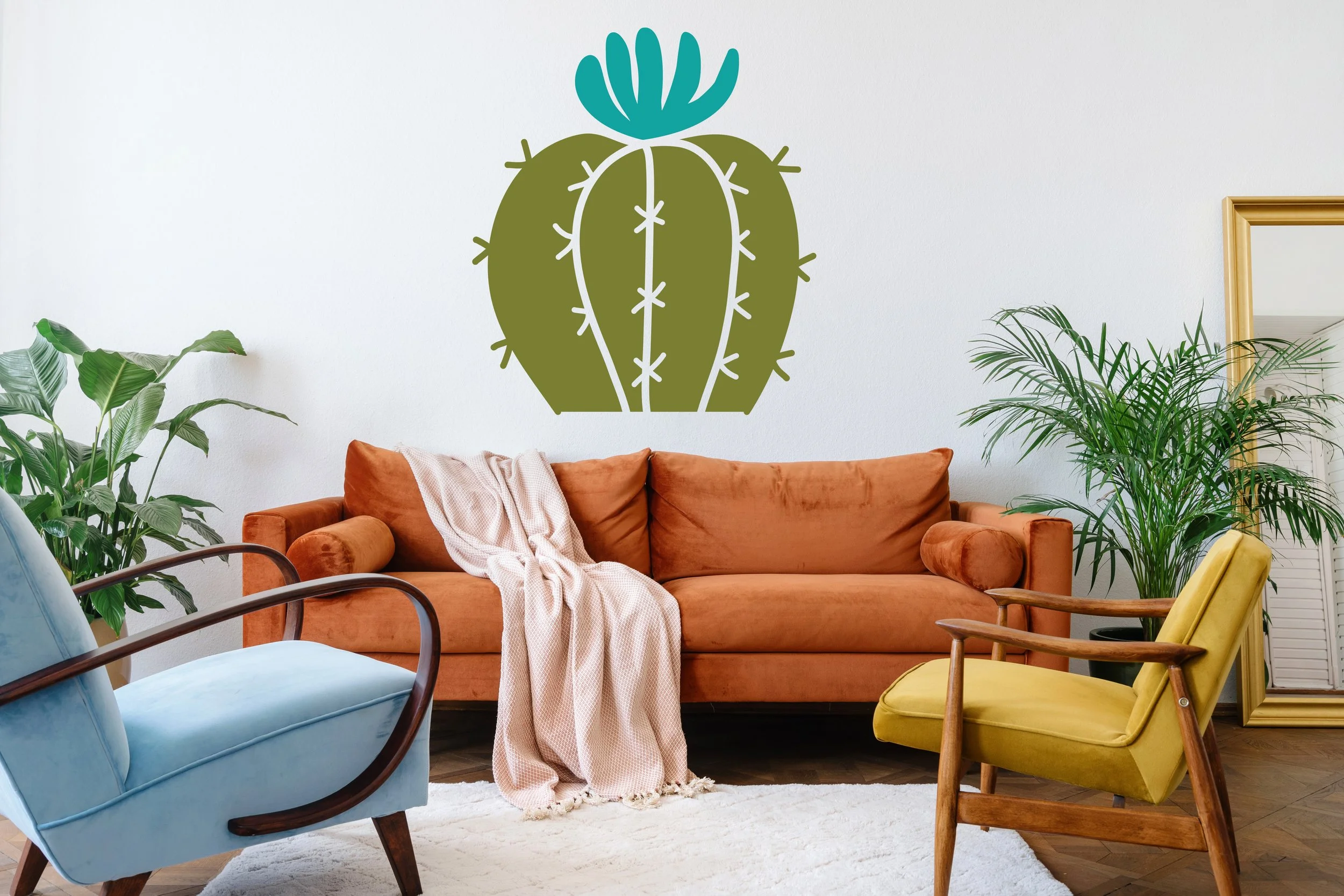 Blooming barrel cactus two color wall decal shown in olive and turquoise on a white wall of a modern living room.