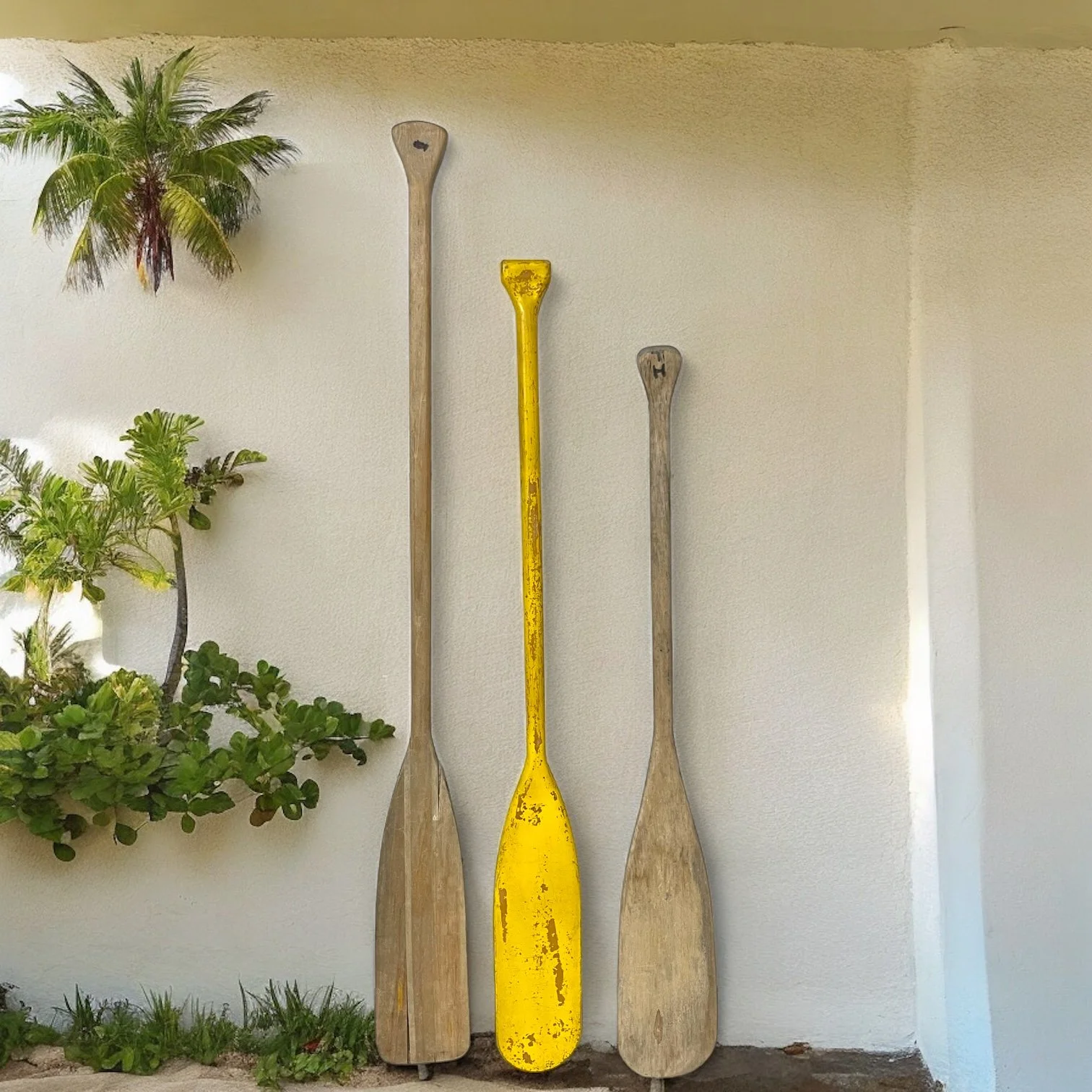 Set of 3 vintage boat oars in various sizes. Two oars are natural weathered wood and one has chippy yellow paint. Smoker's Quality Brand and J & B Products Co.