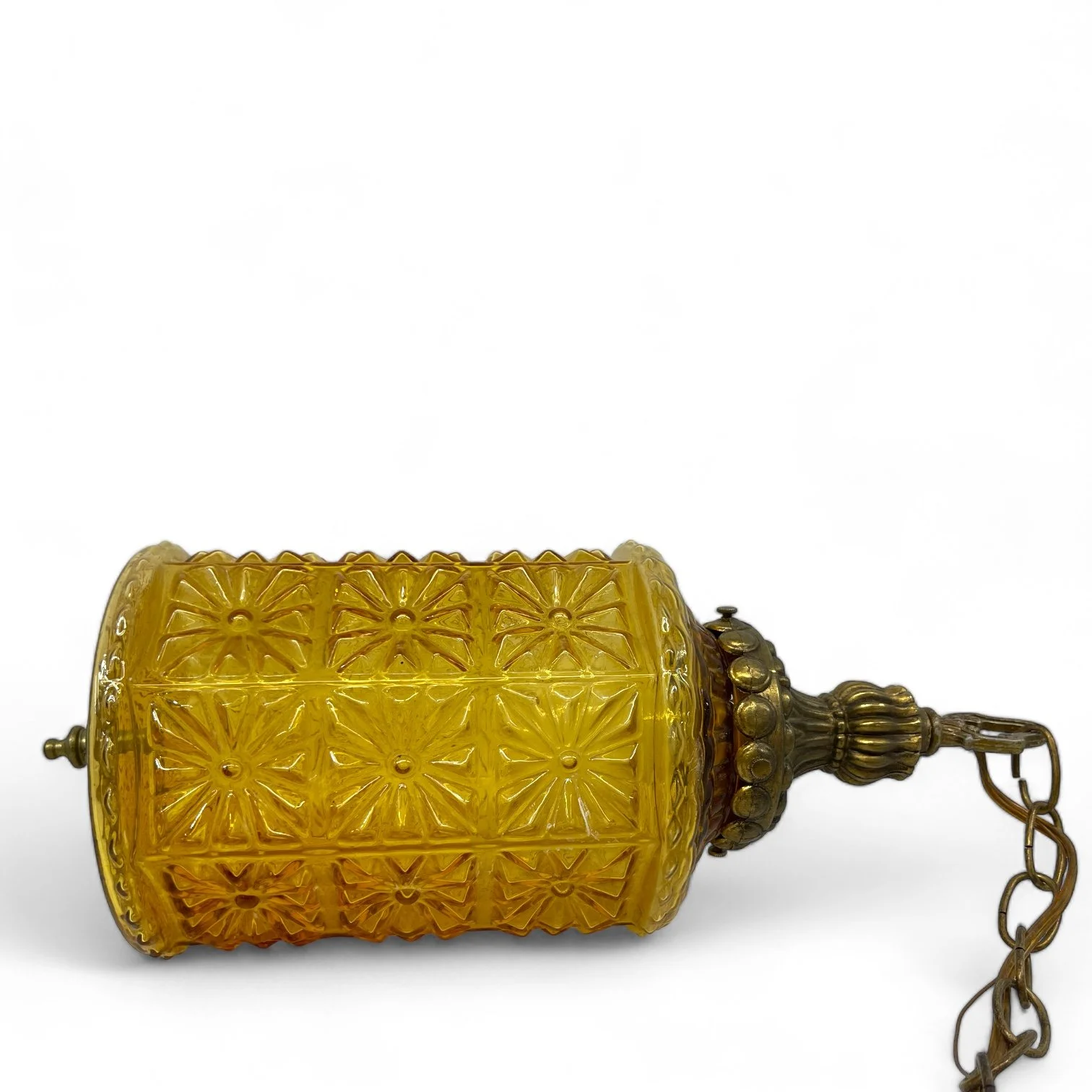 Vintage Mid Century Pendant Hanging Light with chain. Golden Amber Faceted Glass in a geometric floral pattern in a cylinder shape.