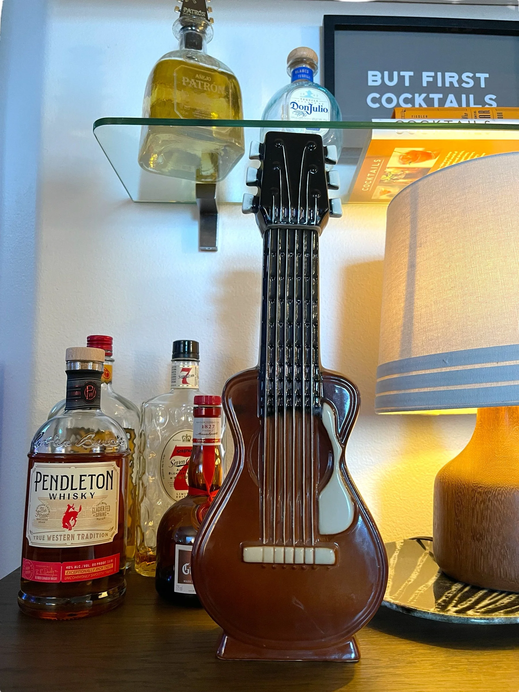 Vintage ceramic guitar liquor decanter 1968 by Old Mister Bourbon styled on a bar cart