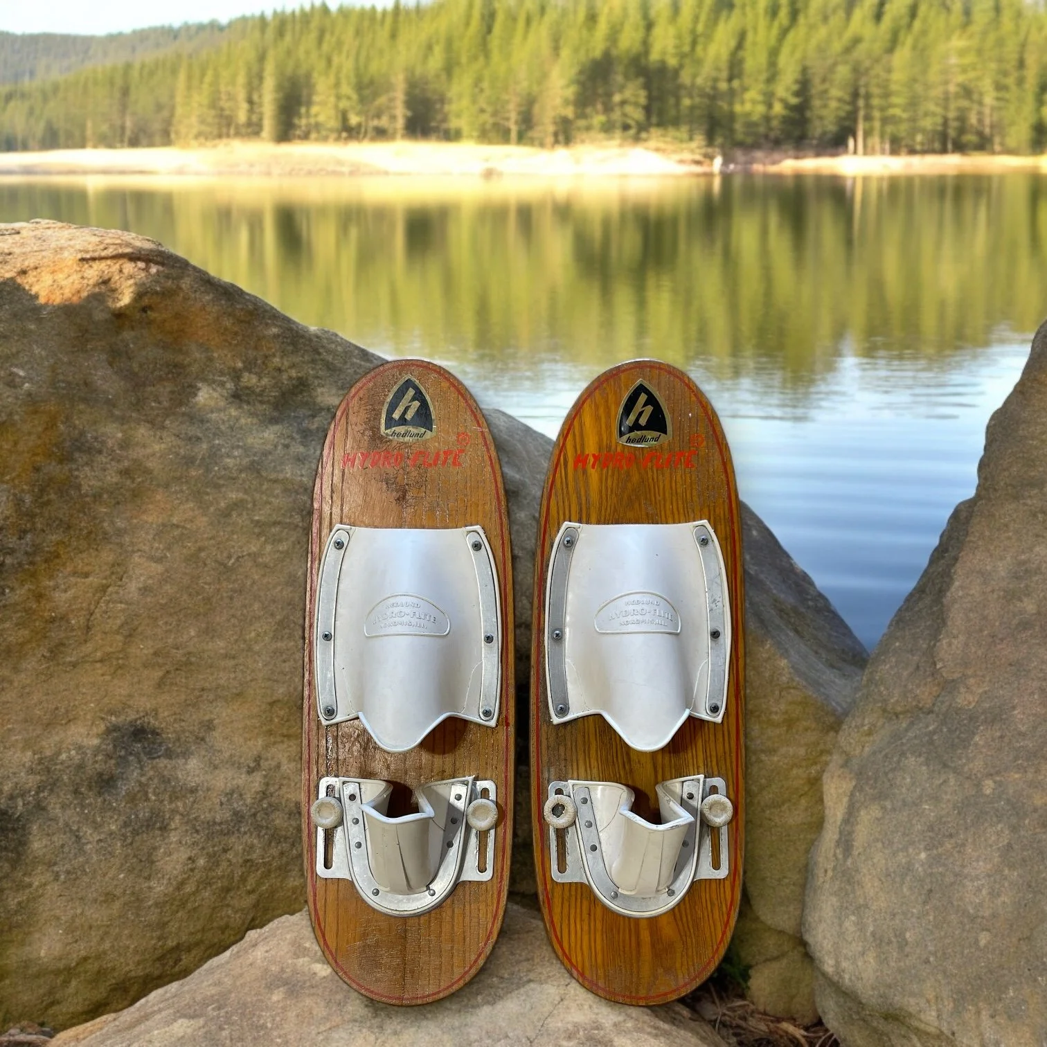 Vintage trick wooden water sky Hedlund Hydro Flite, 1960s made in USA, displayed on a rock with a calm lake in the background.