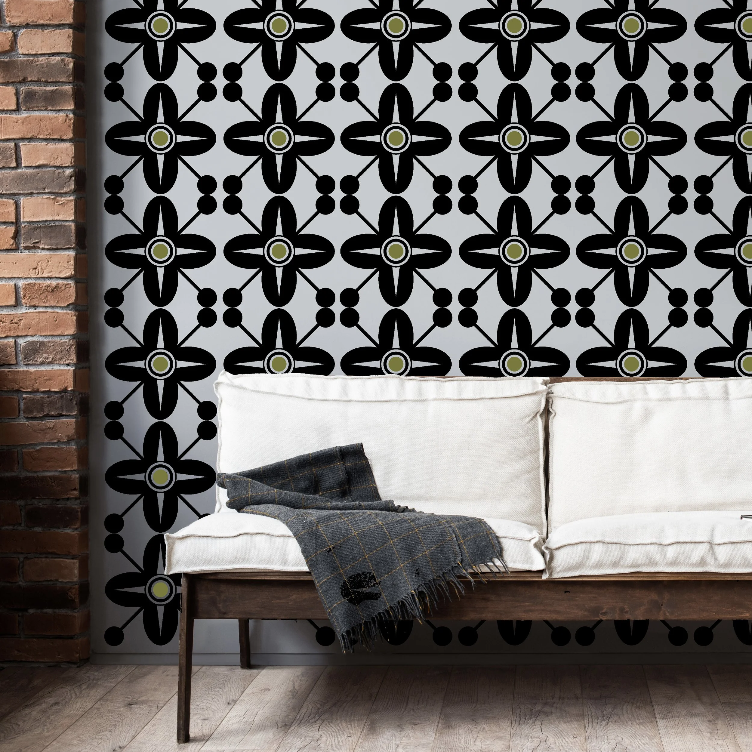 Two color Spanish Revival style wall decal shown in black and olive on a light grey wall of a modern living room.