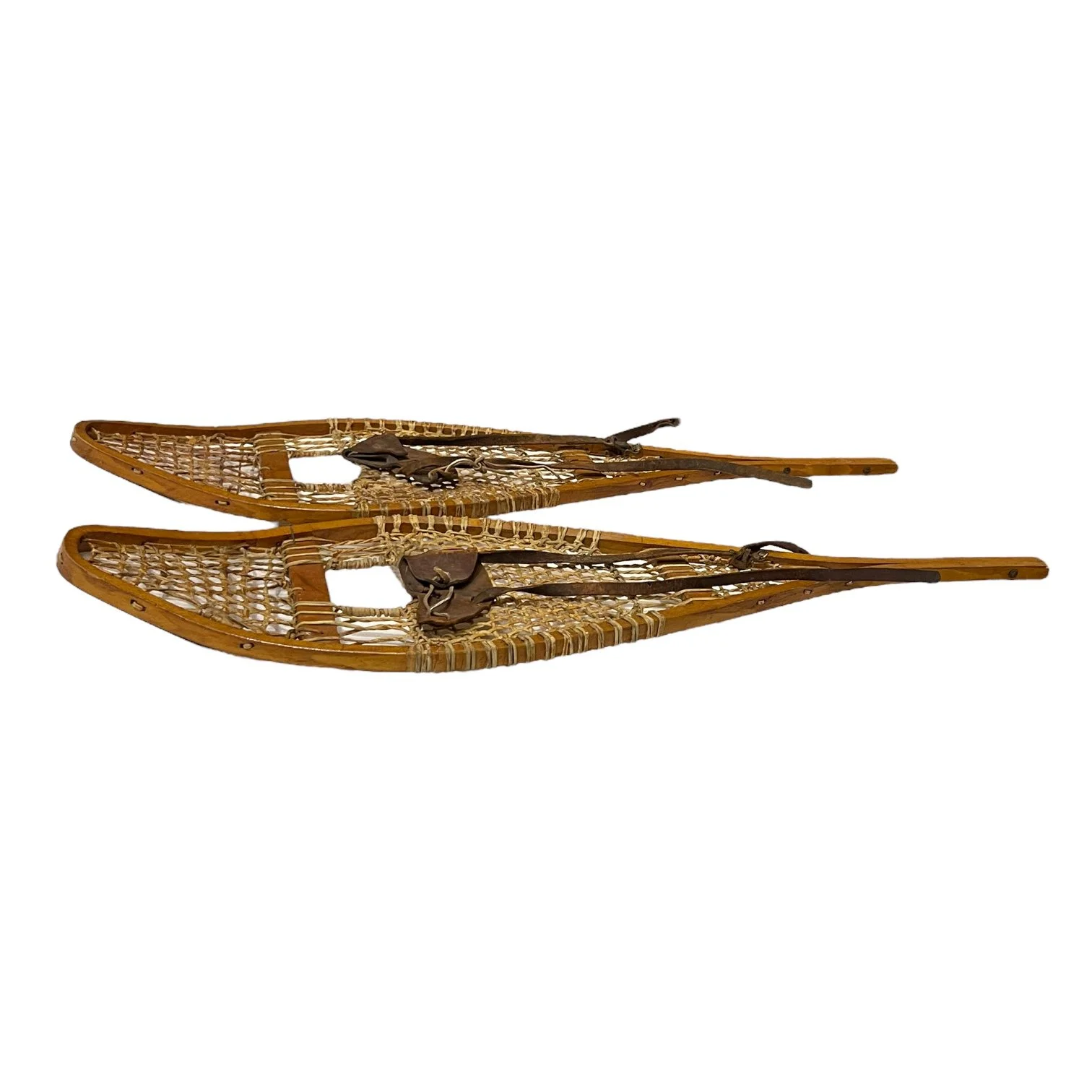 Pair of vintage cross country snowshoes from the 1940s with leather bindings.