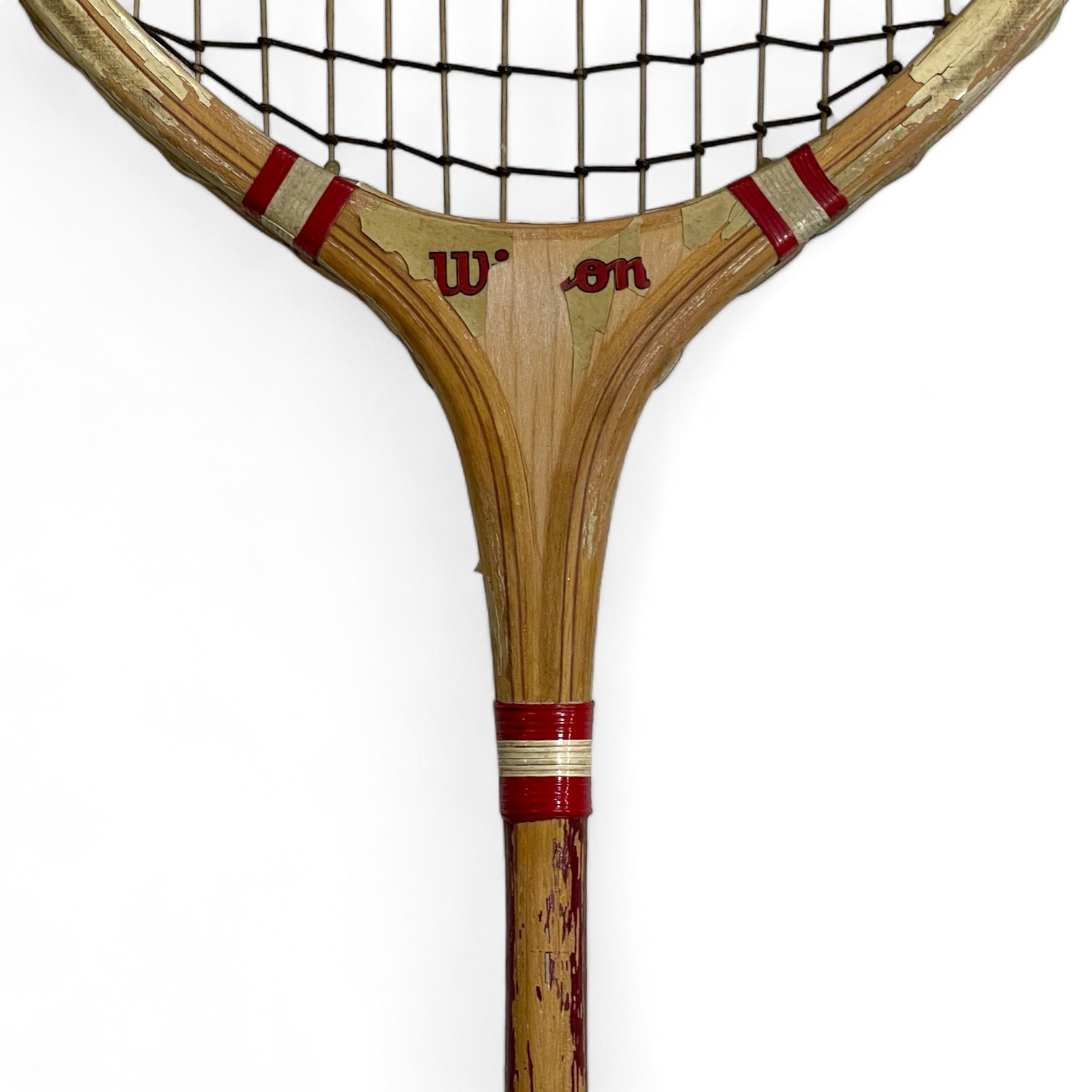 Vintage pair of red and blue Wilson badminton rackets with wooden press.