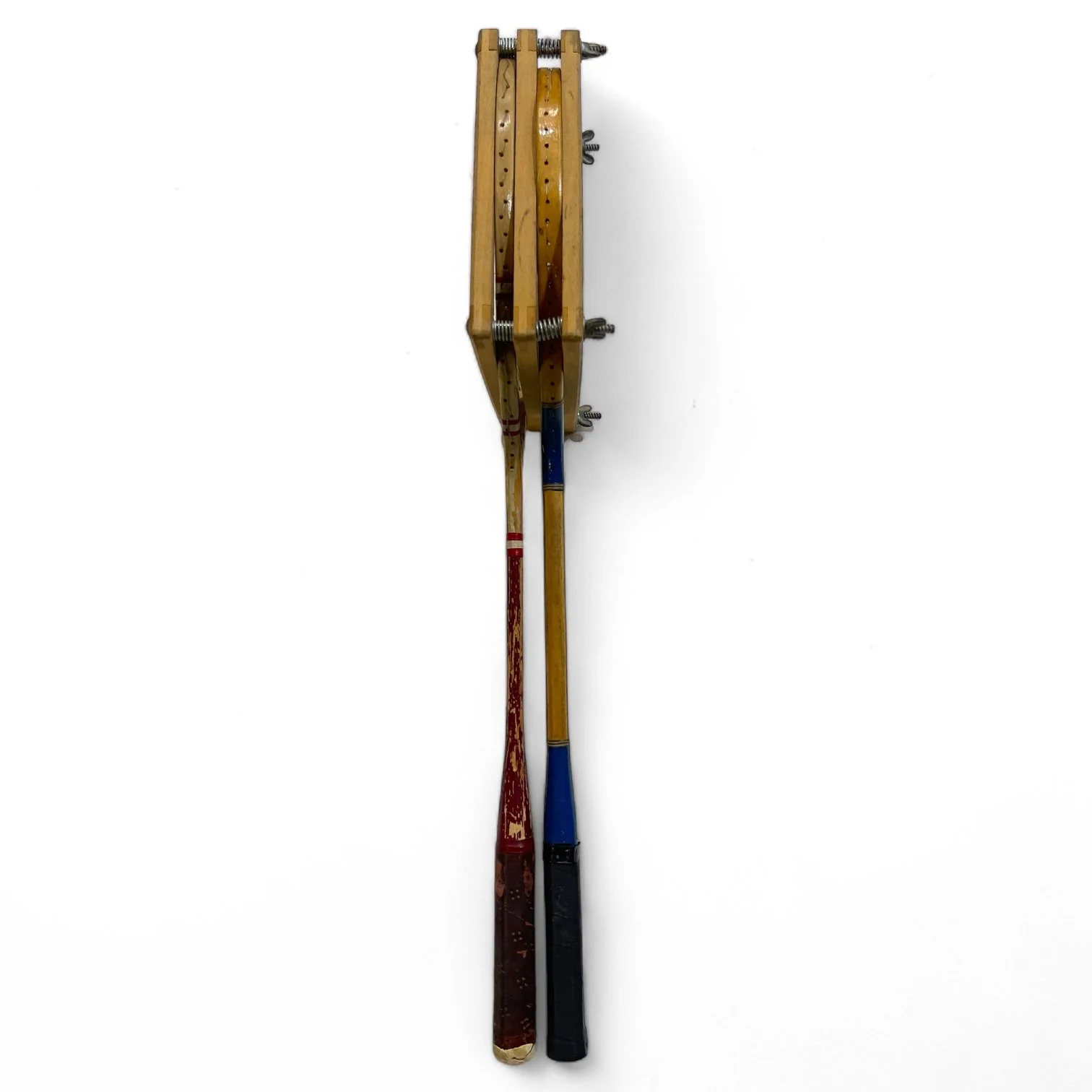 Vintage pair of red and blue Wilson badminton rackets with wooden press.