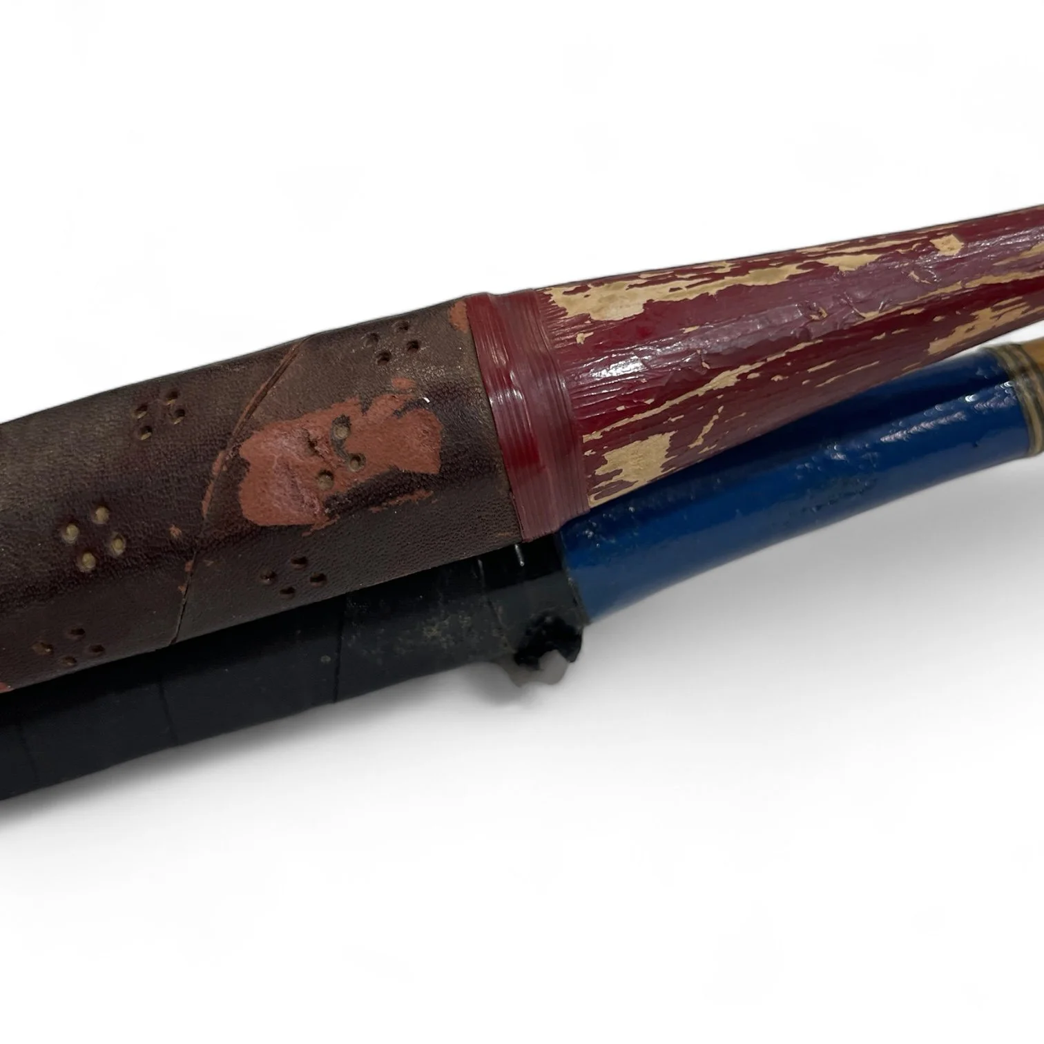 Vintage pair of red and blue Wilson badminton rackets with wooden press.