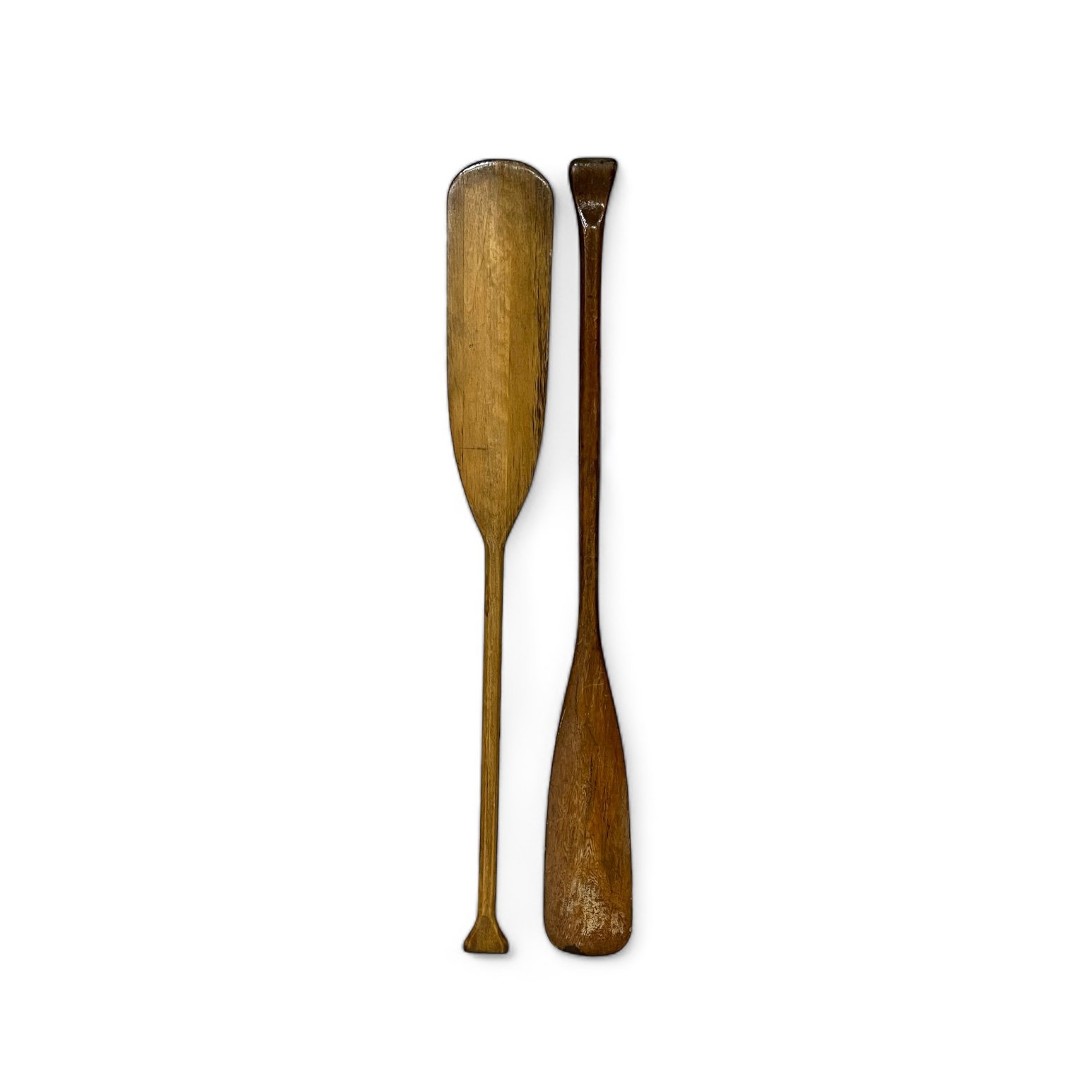 Vintage pair of rustic wooden boat oars paddles with a clear gloss coating.