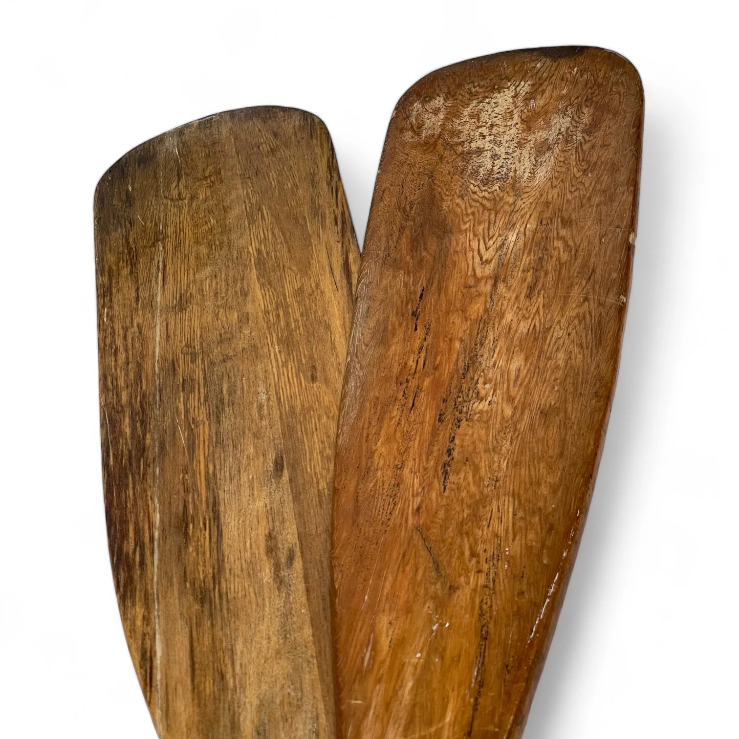 Vintage pair of rustic wooden boat oars paddles with a clear gloss coating.