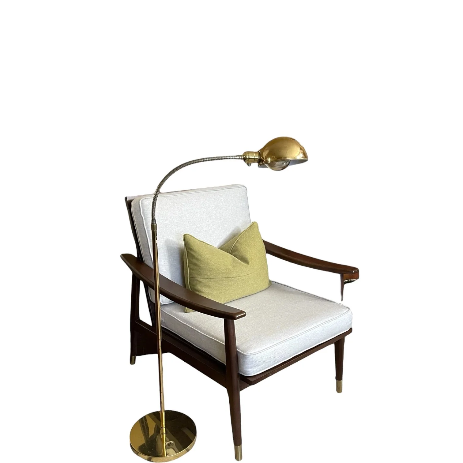Vintage mid century gold pharmacy gooseneck floor lamp next to a modern occasional chair with a throw pillow.
