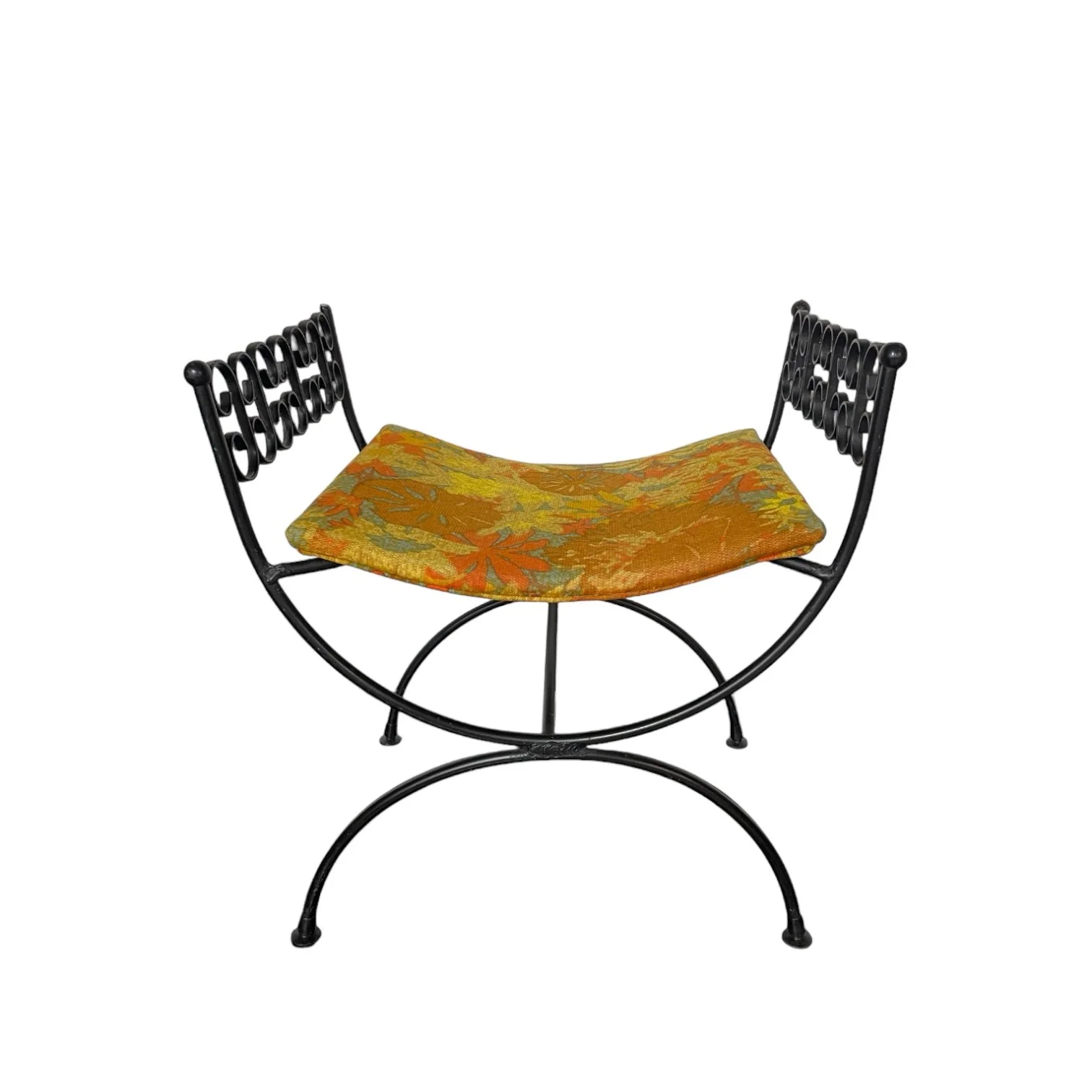 Vintage vanity stool chair made of black wrought iron with a curved 70s retro floral seat consisting of yellows, oranges, greens from Modern Artifact Decor.