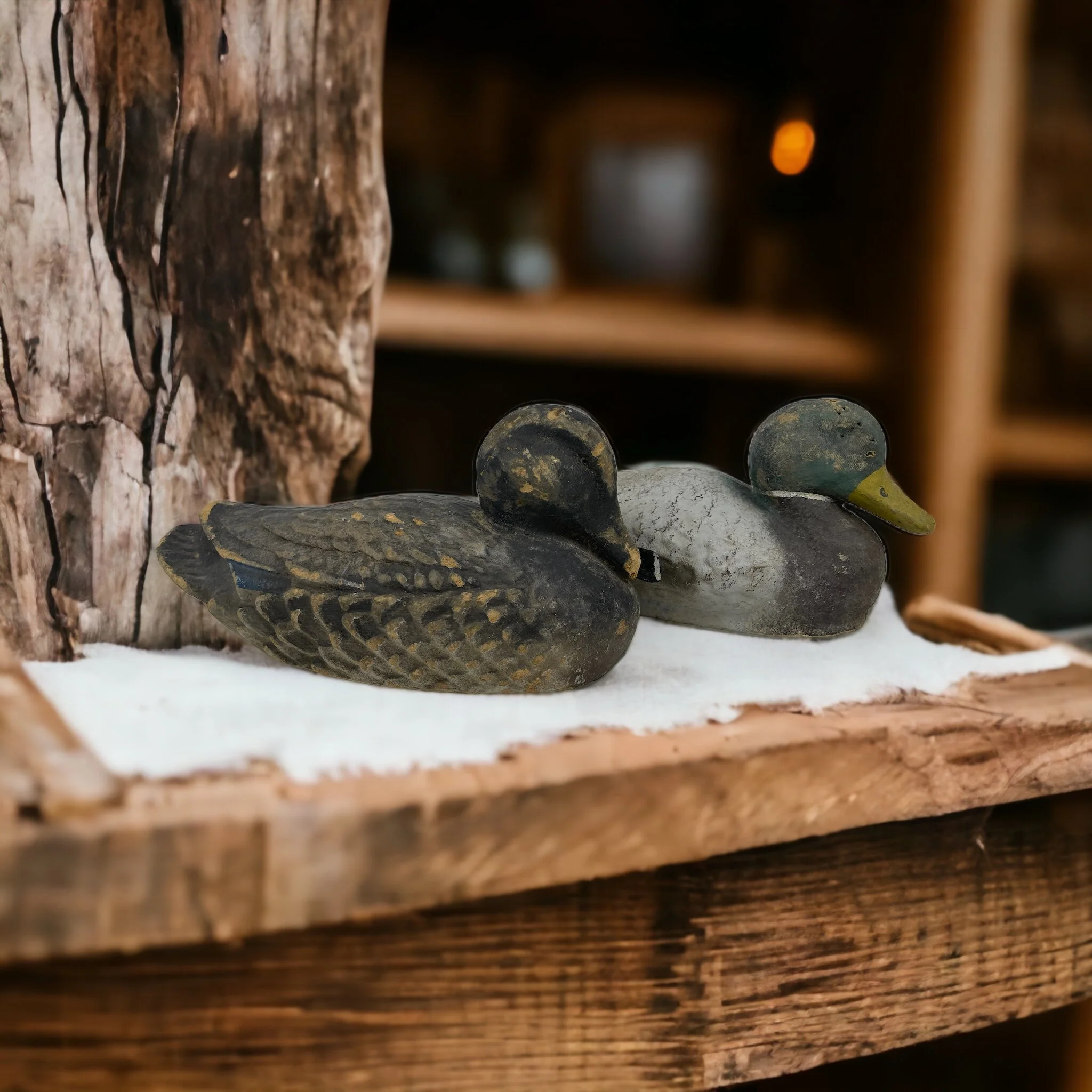 Vintage pair of paper machete fiber duck decoys. Set of two Mallard duck decoys by Carry Lite, JC Higgins, styled on a rustic wooden shelf in a cabin.