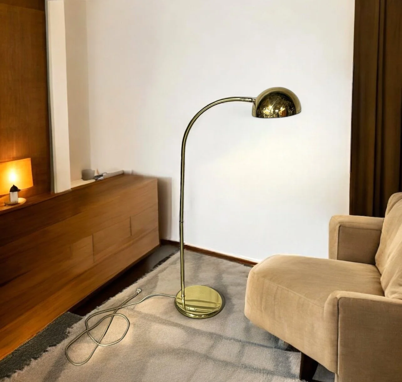 Vintage mid century modern gold arched floor lamp next to a couch in a mid century living room.