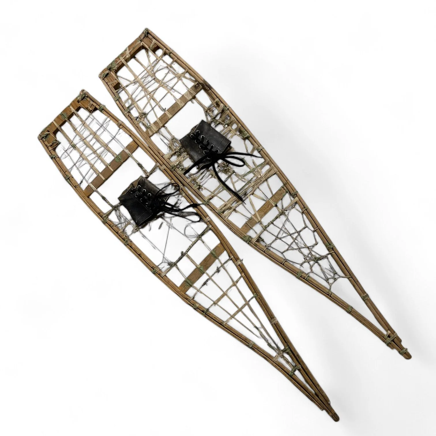Rare and unique handcrafted vintage wooden snowshoes, featuring square toe frame, string, leather bindings.