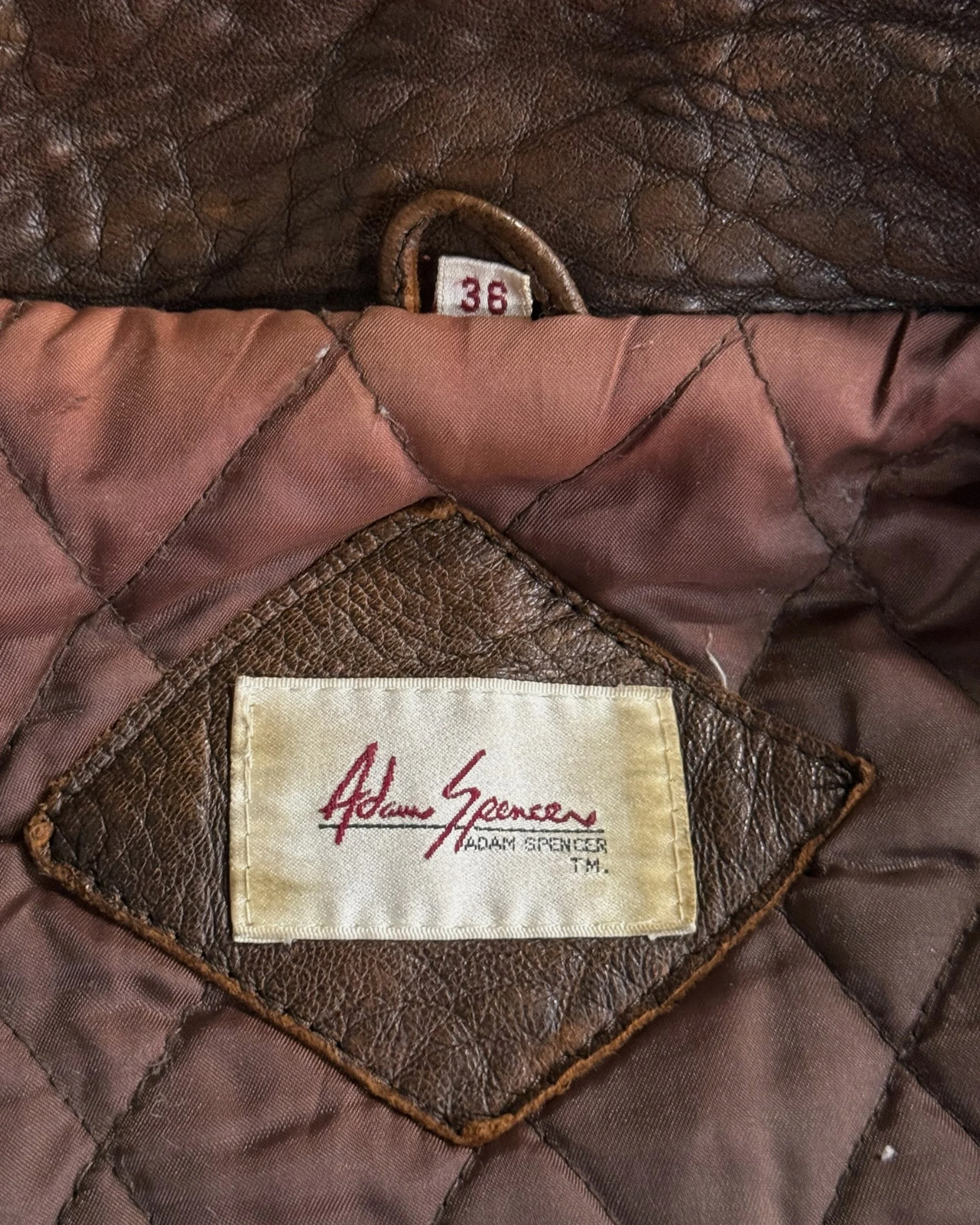 Adam Spencer label on a 1980s vintage brown leather bomber jacket