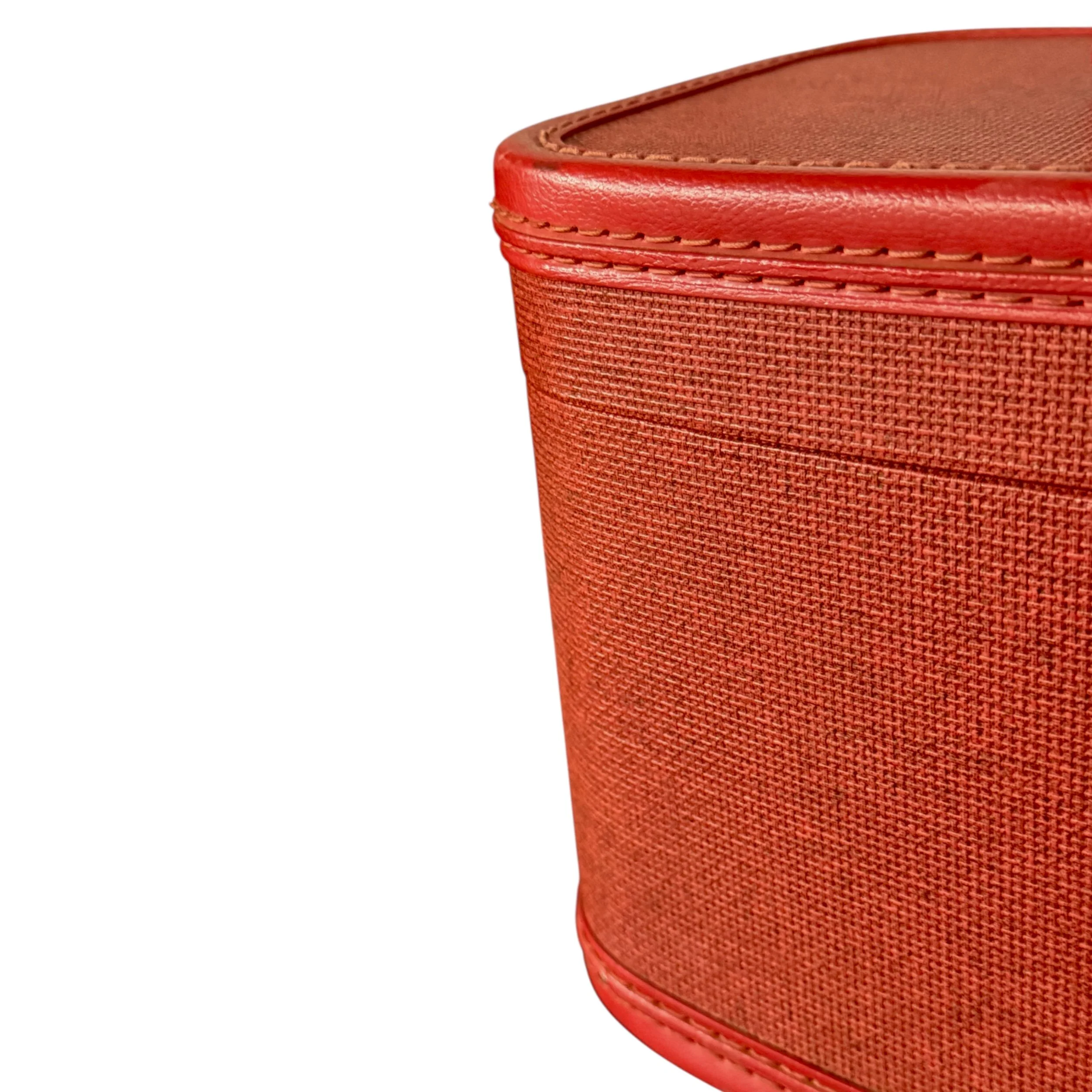 Close-up of vinyl texture and stitching on red vintage 60s makeup storage case
