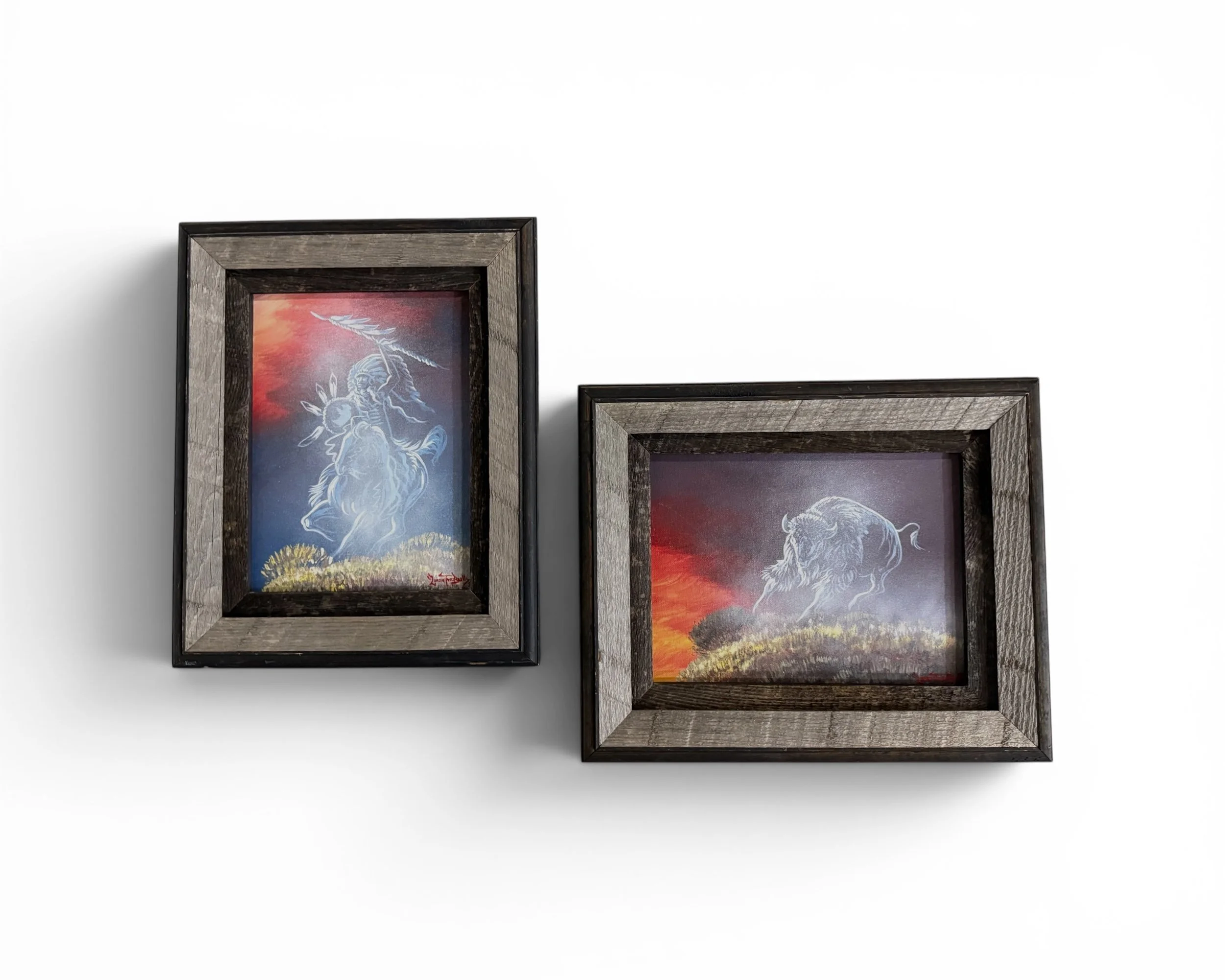 Pair of vintage barn wood framed original paintings signed and dated by Loren Two Bulls featuring Native American horseman and buffalo at sunset.