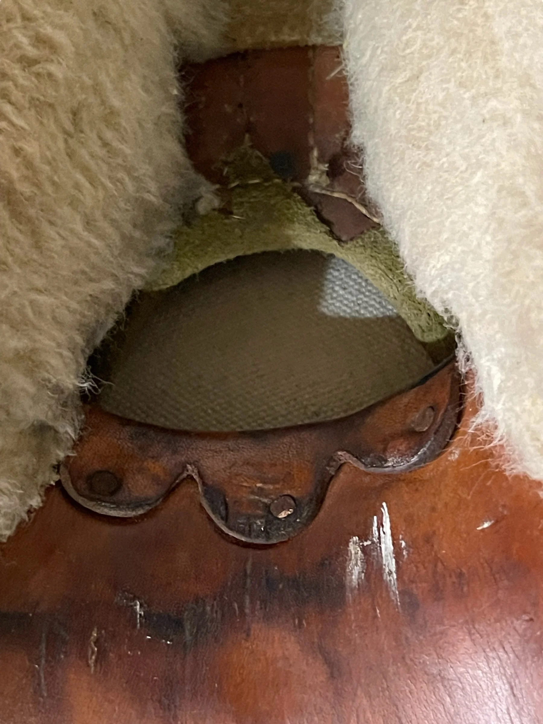 Vintage brown Western tooled leather horse saddle with green padded suede seat, perfect for trail riding or ranch, lodge, and cabin decor.