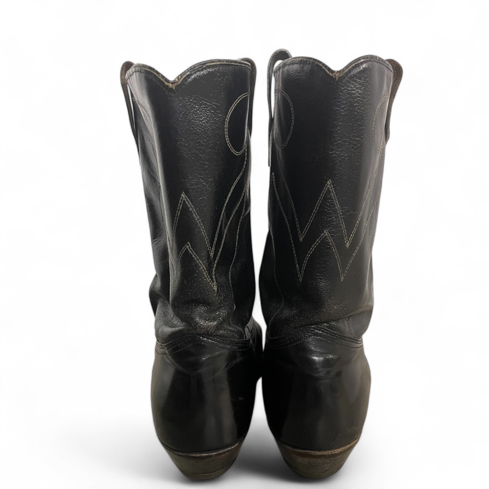 Vintage mens black leather cowboy boots by Wrangler, size 13, mid shaft, classic R toe, pull strap, minimalist stitching, western heel.