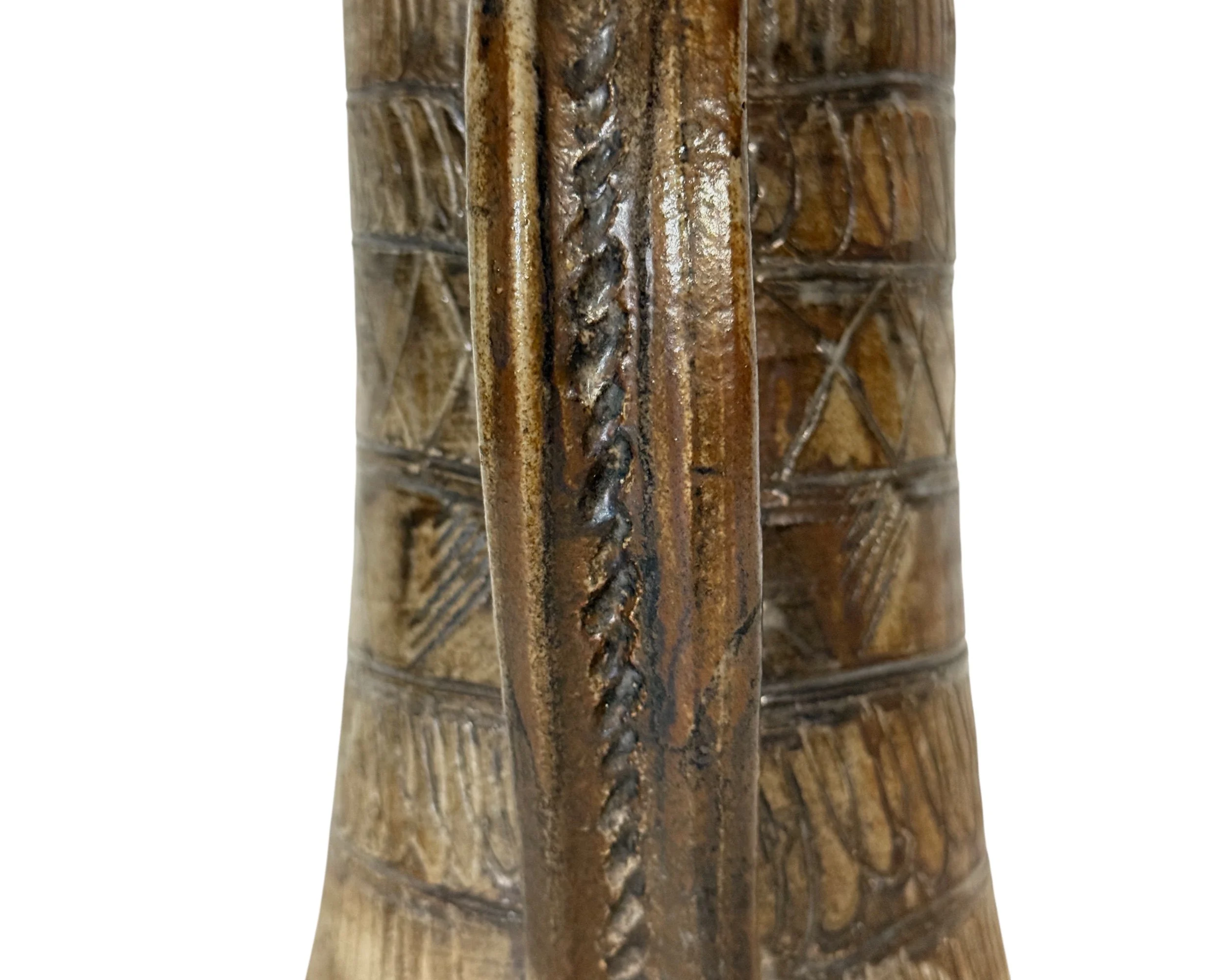 Close-up detail of etched geometric patterns on vintage pottery