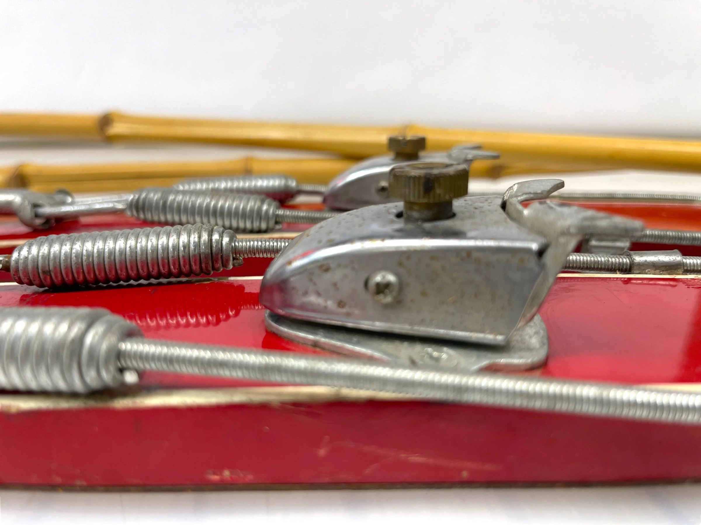 Close up view of metal bindings on a pair of vintage mid century kids Alpine snow skis.