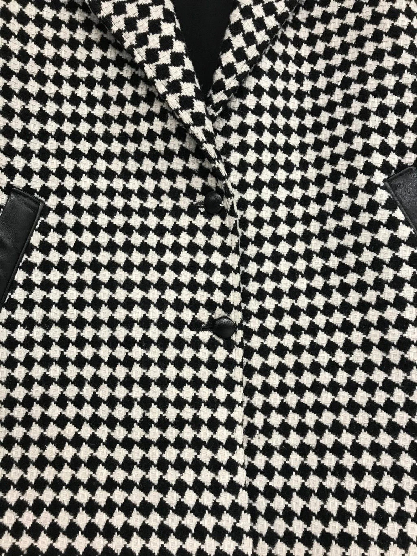 Vintage Pioneer Wear womens size medium black and white houndstooth coat, fully lined, trimmed in black leather, button front closure, two side pockets.