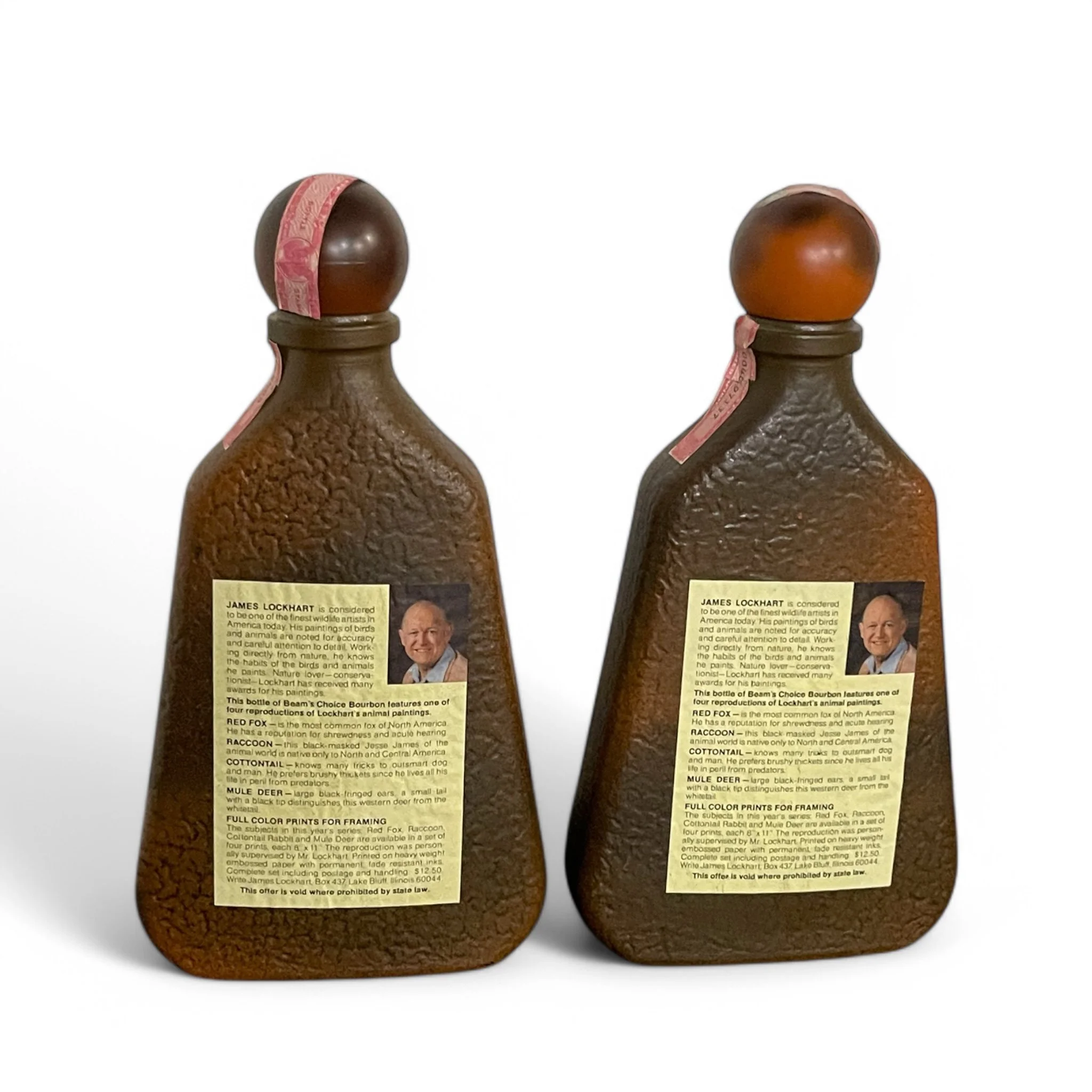 Pair of vintage 1970s Beams Choice whiskey liquor bottles featuring wildlife designs of a mule deer and a red fox by James Lockhart. Perfect for collectors or  home bar decor.