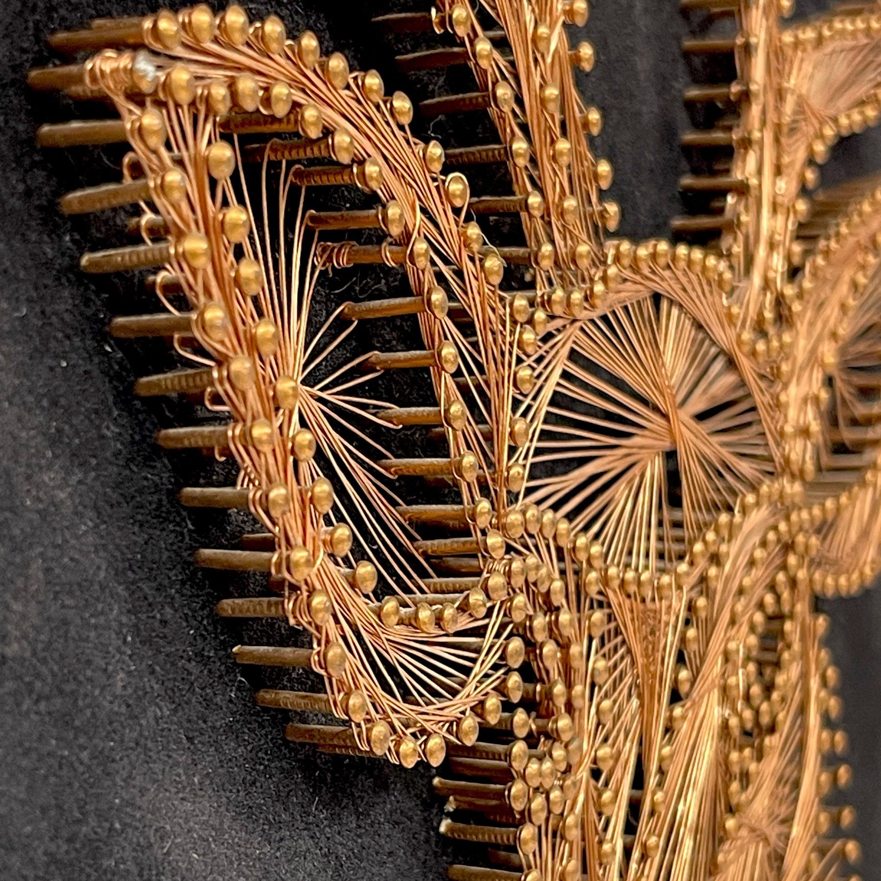 Vintage copper string art of a male deer, buck, on a black velvet board.