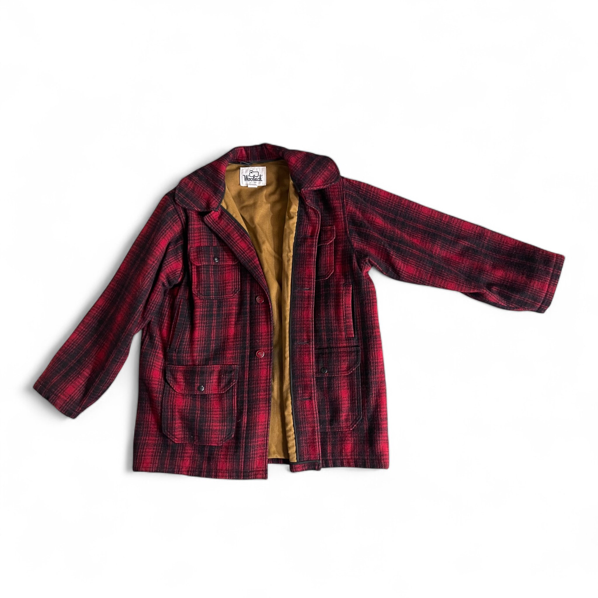 Vintage 70s Woolrich black red plaid jacket. Size 46 long, fully lined, hidden button front closure with 6 front pockets with snap closure,  full game pocket. This Mackinaw style coat Made in USA.
