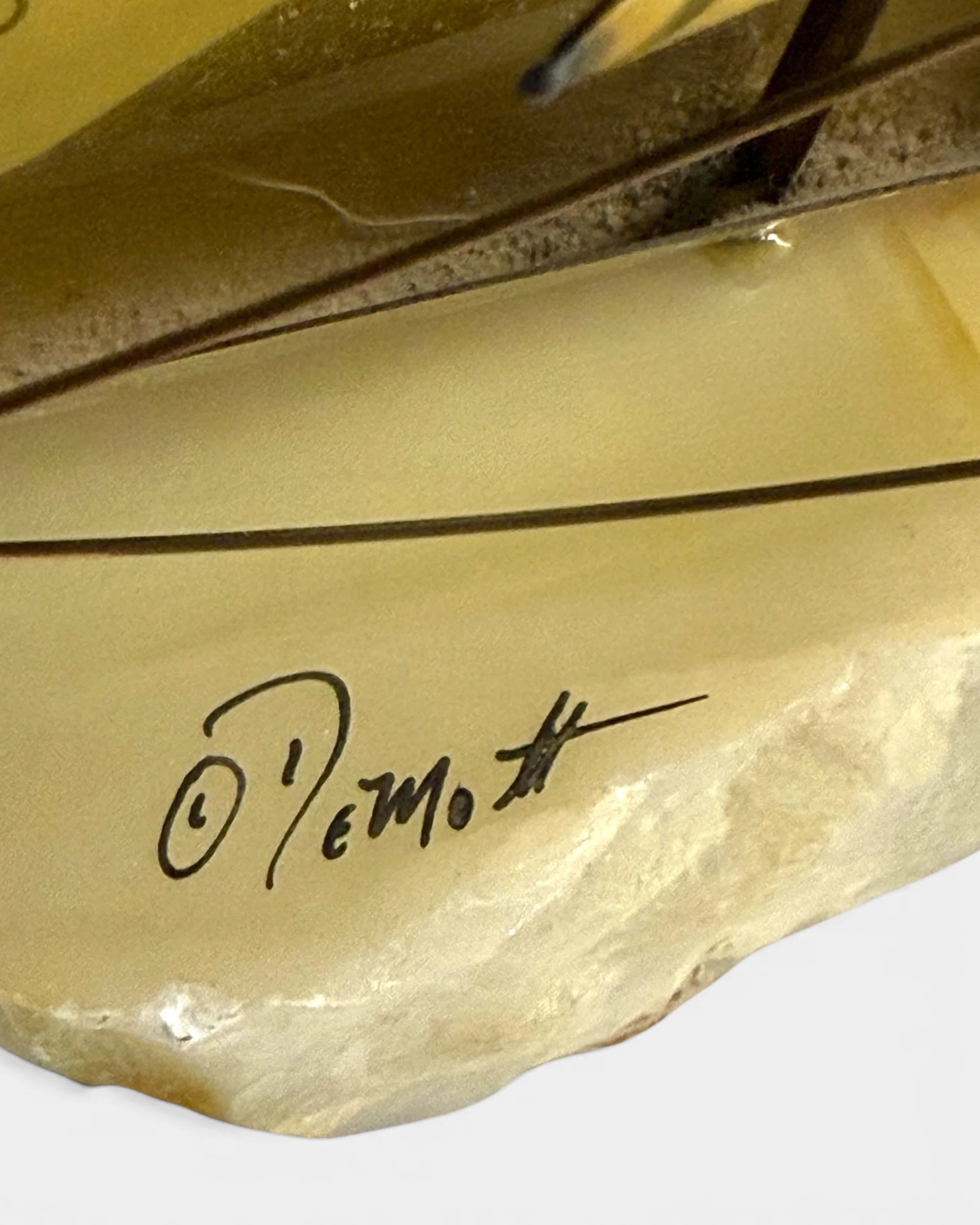 Signed DeMott sailboat sculpture mounted on natural stone base.