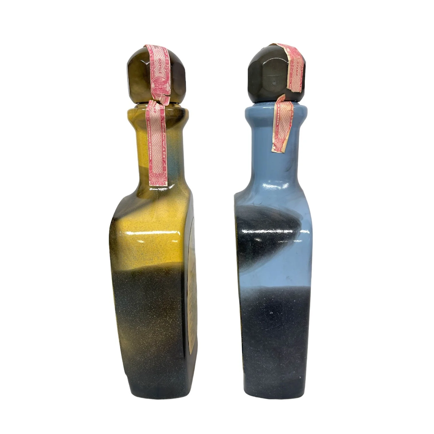 Vintage pair of glass 1970s Jim Beam Choice liquor bottles, featuring the cowboy and the Indian trapper. Perfect home bar decor.